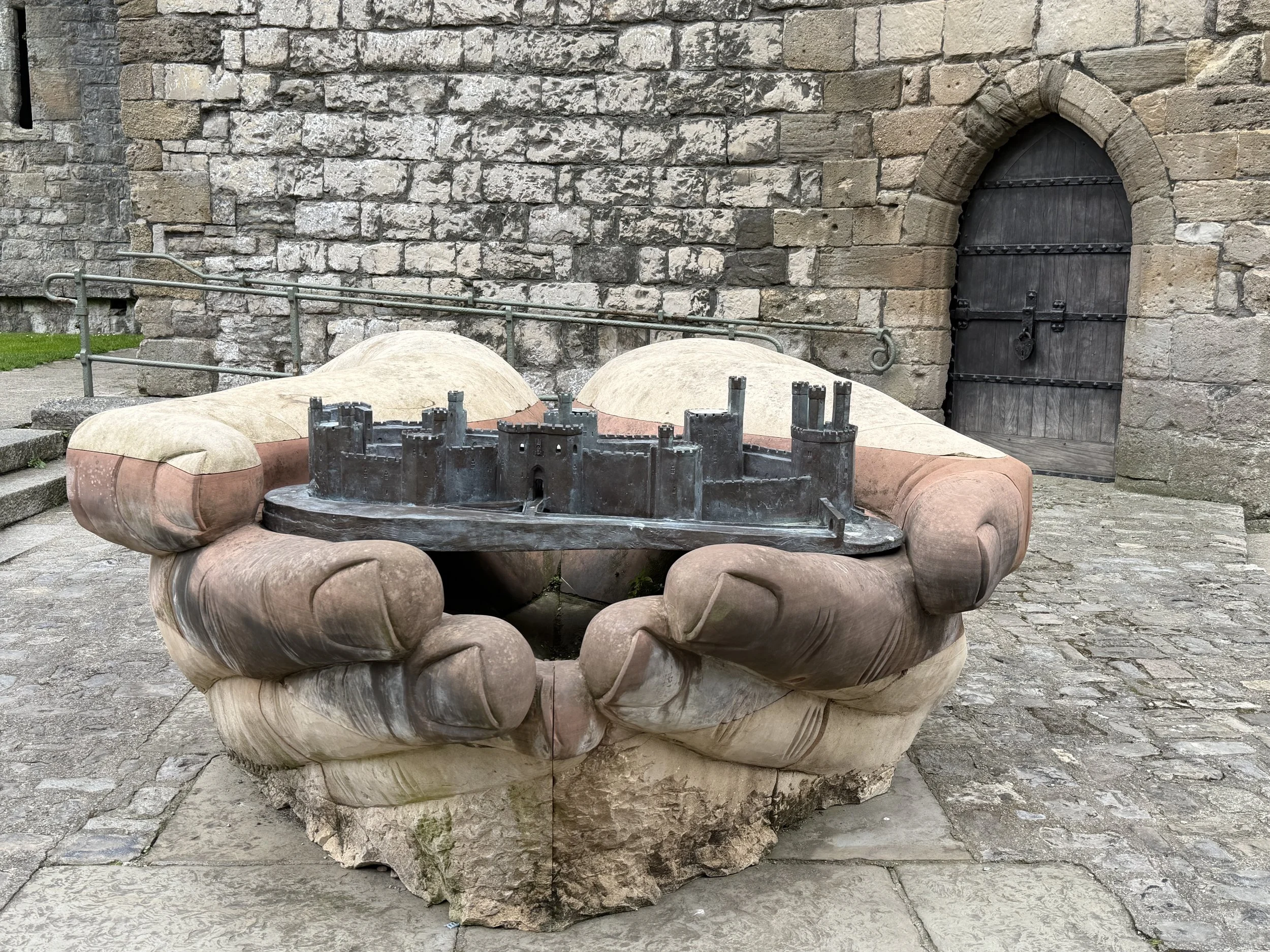   This is a bronze sculpture titled  The Hands That Built the Castle , installed in 2023.   