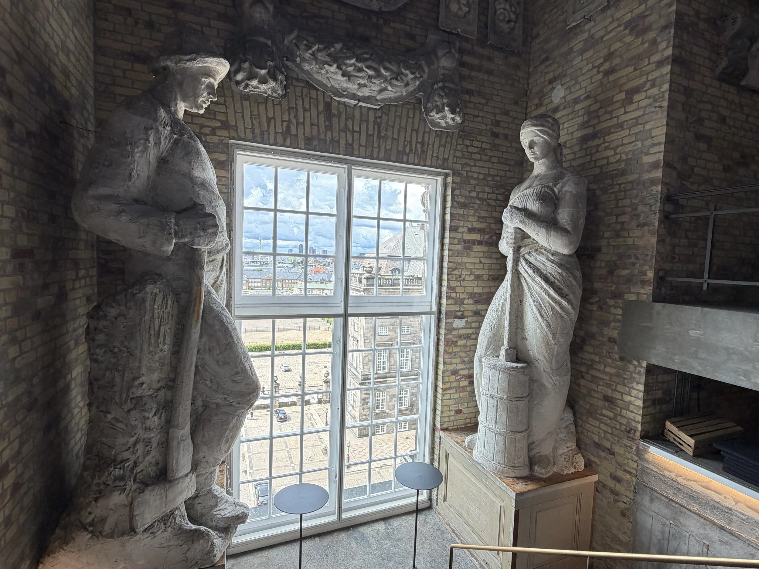   11 meter tall sculpture of a dairymaid churning butter and a forester. These are replicas of the copper figures that adorn the tower's spire.  