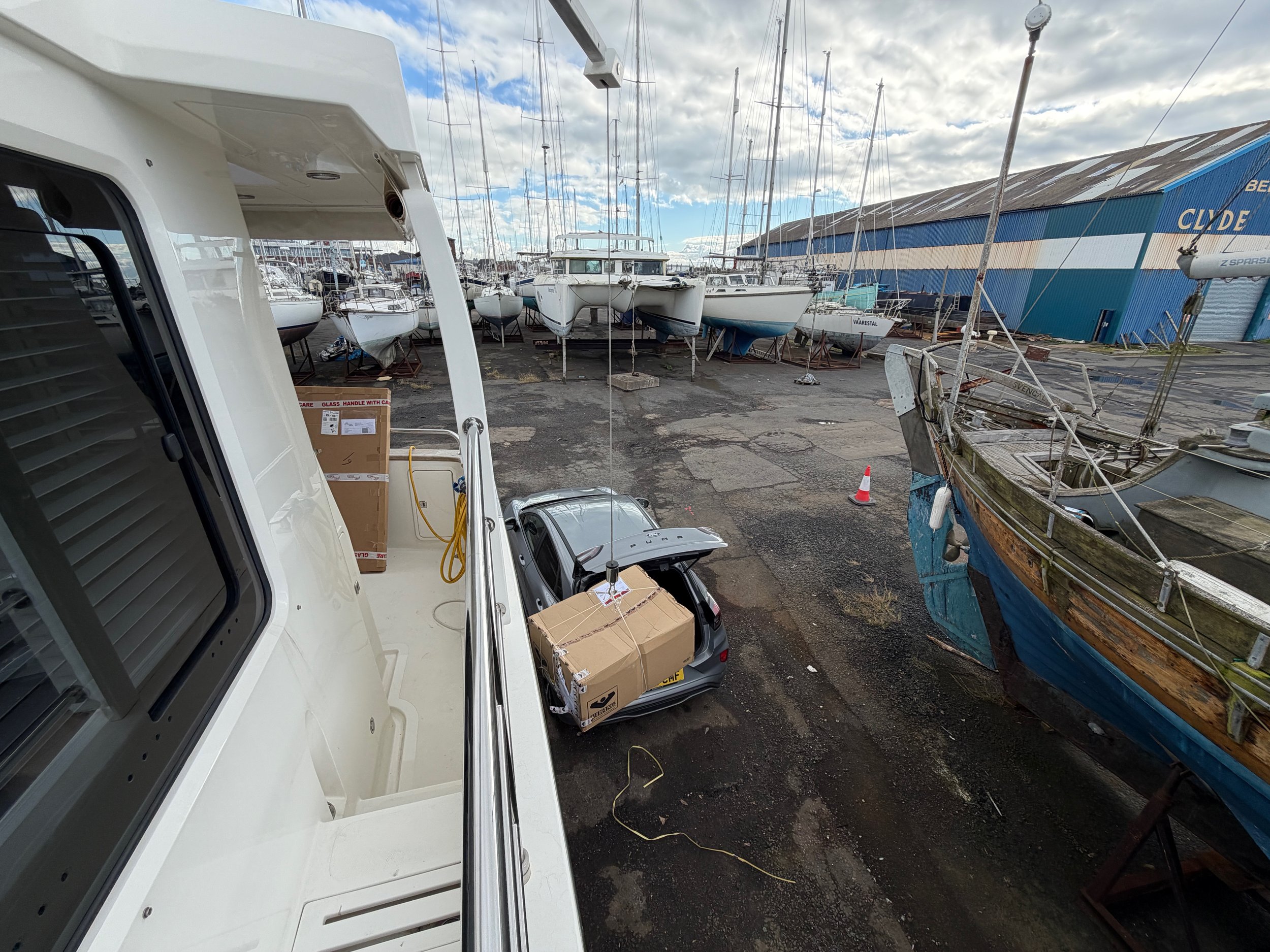   Using the davit to raise the raft.  It is too heavy to carry up the ladder.  