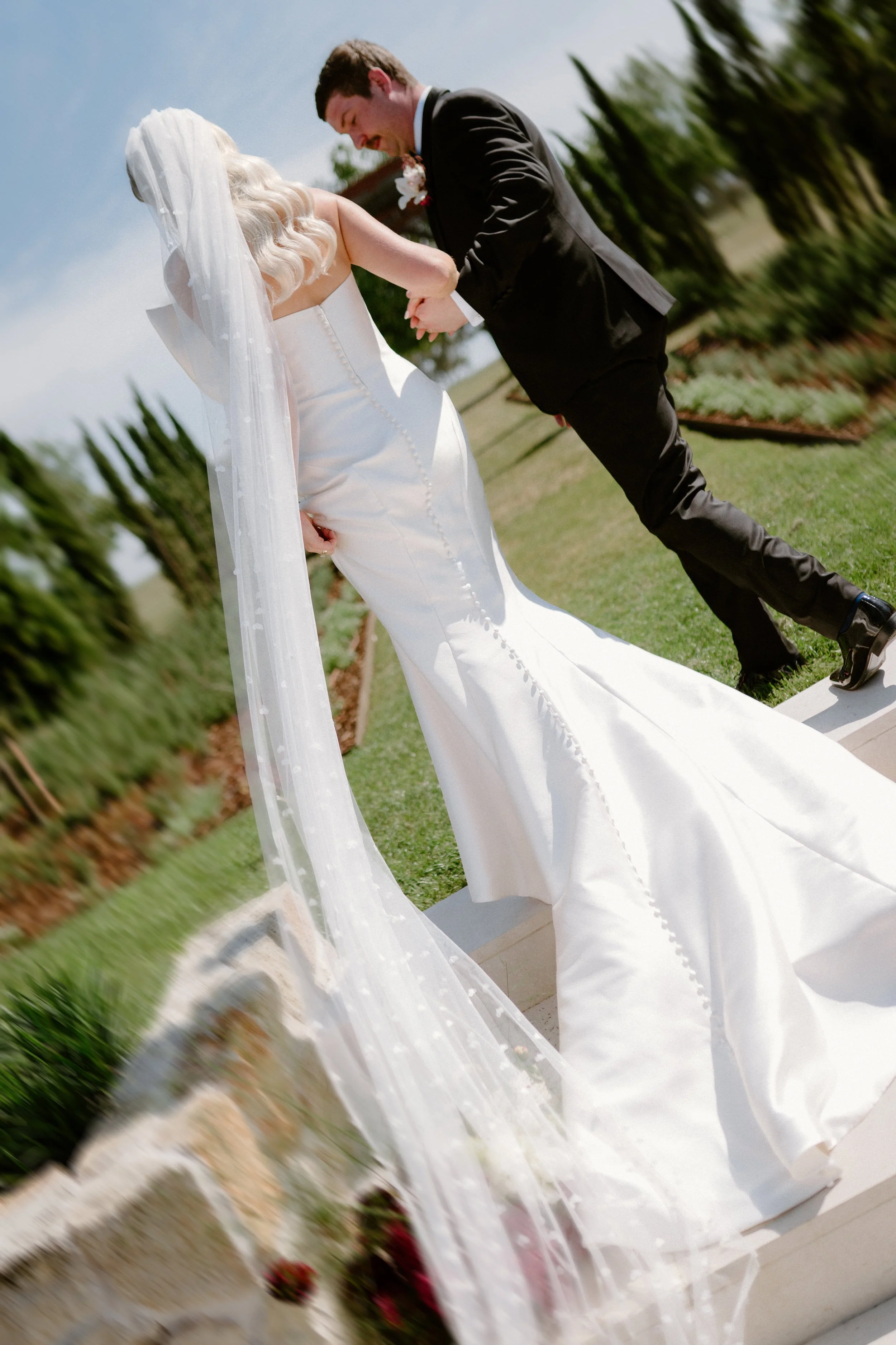 The Sienna, Hunter Valley Wedding Venue, Wedding Photos. Bride and groom holding hands during their wedding ceremony outdoors on a sunny day.