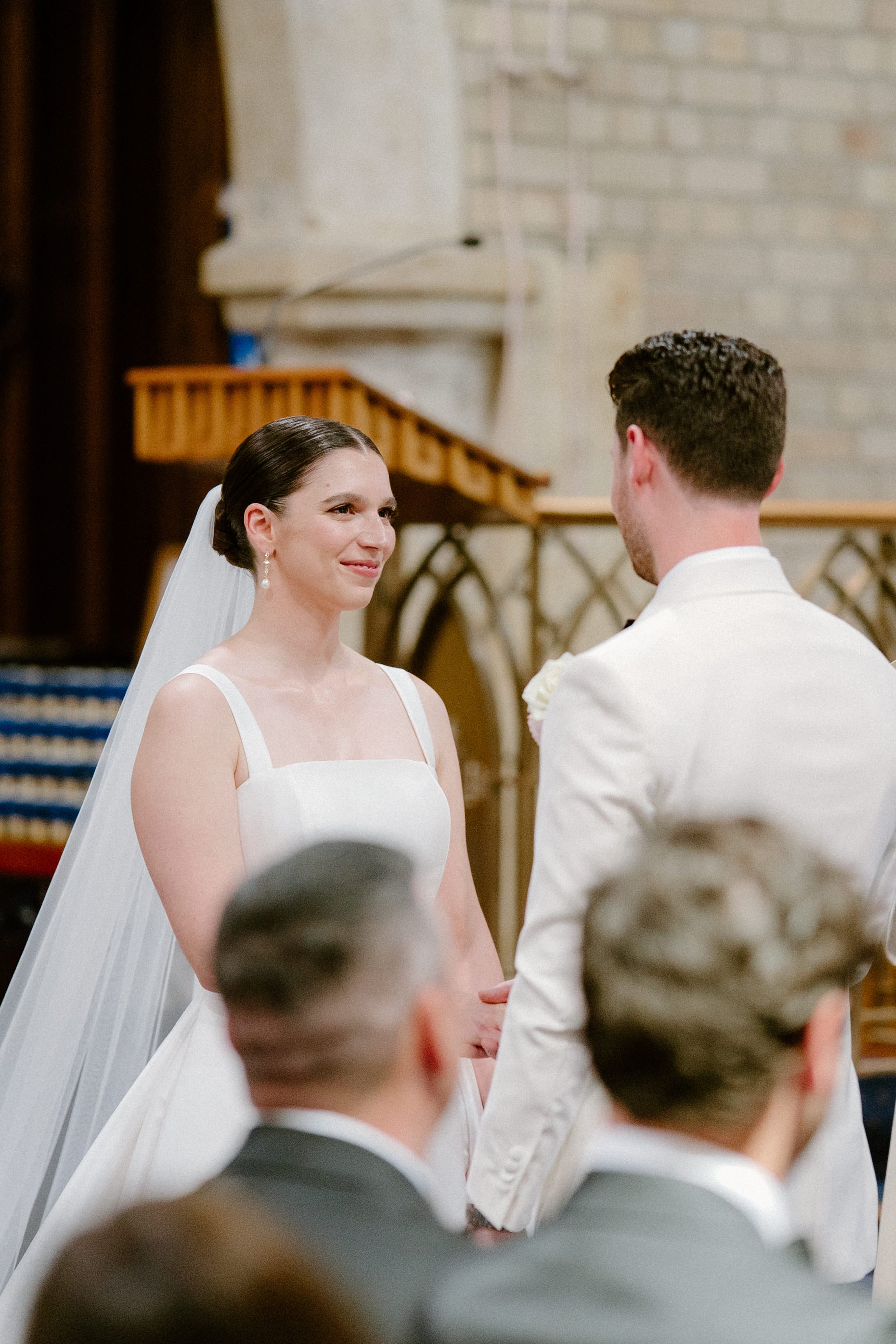 Bride and groom exchanging vows during wedding ceremony in a church.