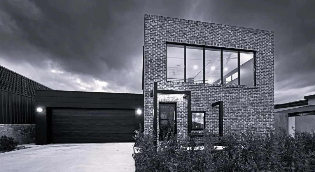 Black and white photo of a modern brick house
