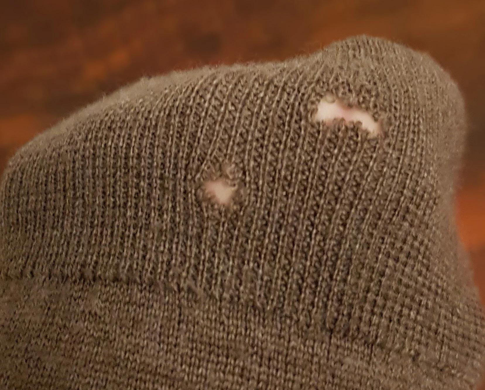 darning holes in a woolen sweater