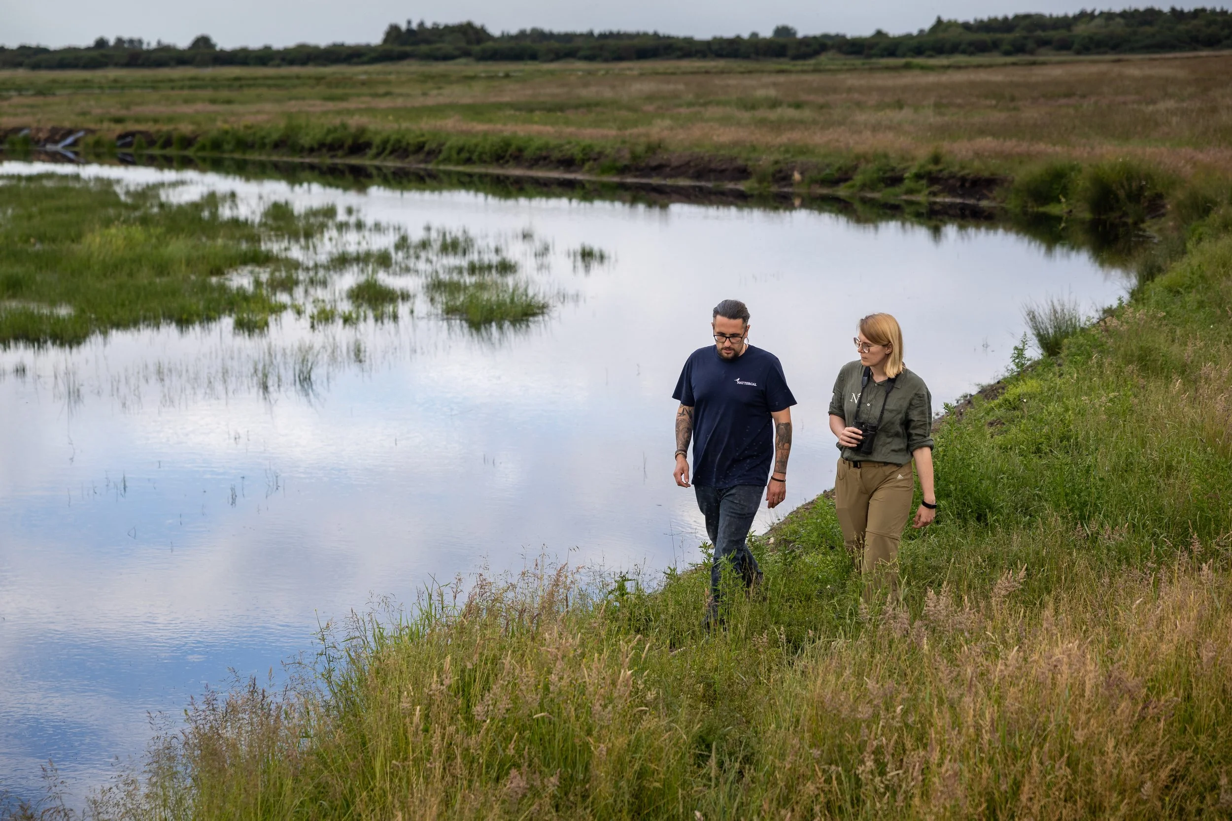 Two people walking in High Fen wildland
