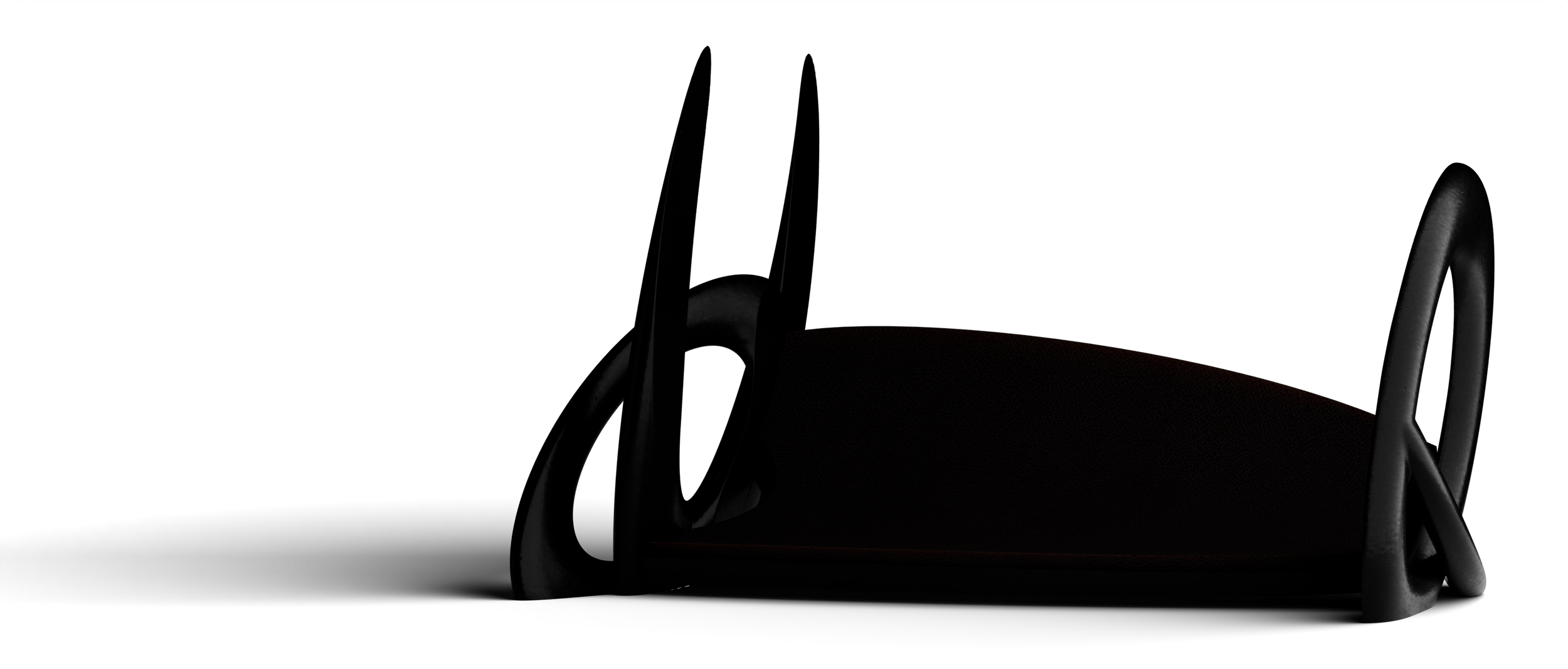 Part of a dark medical or sports chair with a metal frame and a padded seat visible in low light.