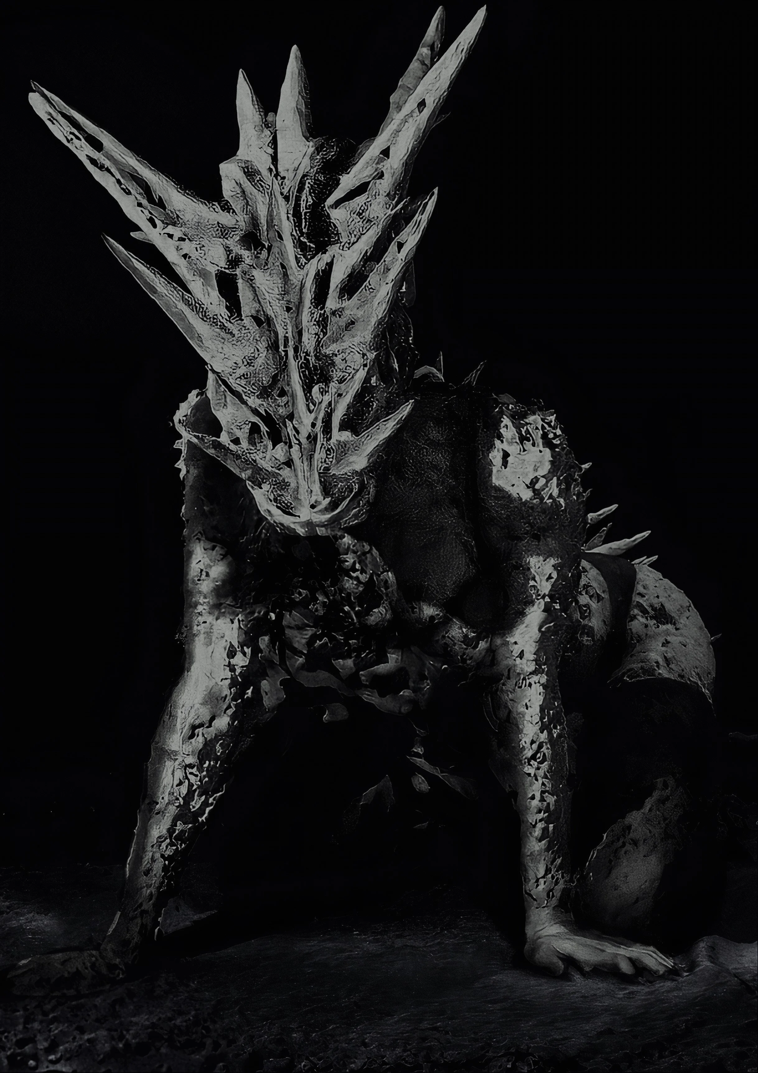 A creature with a humanoid form featuring spikes and armor-like textures, with a prominent head adorned with sharp, elongated structures, set against a dark background.