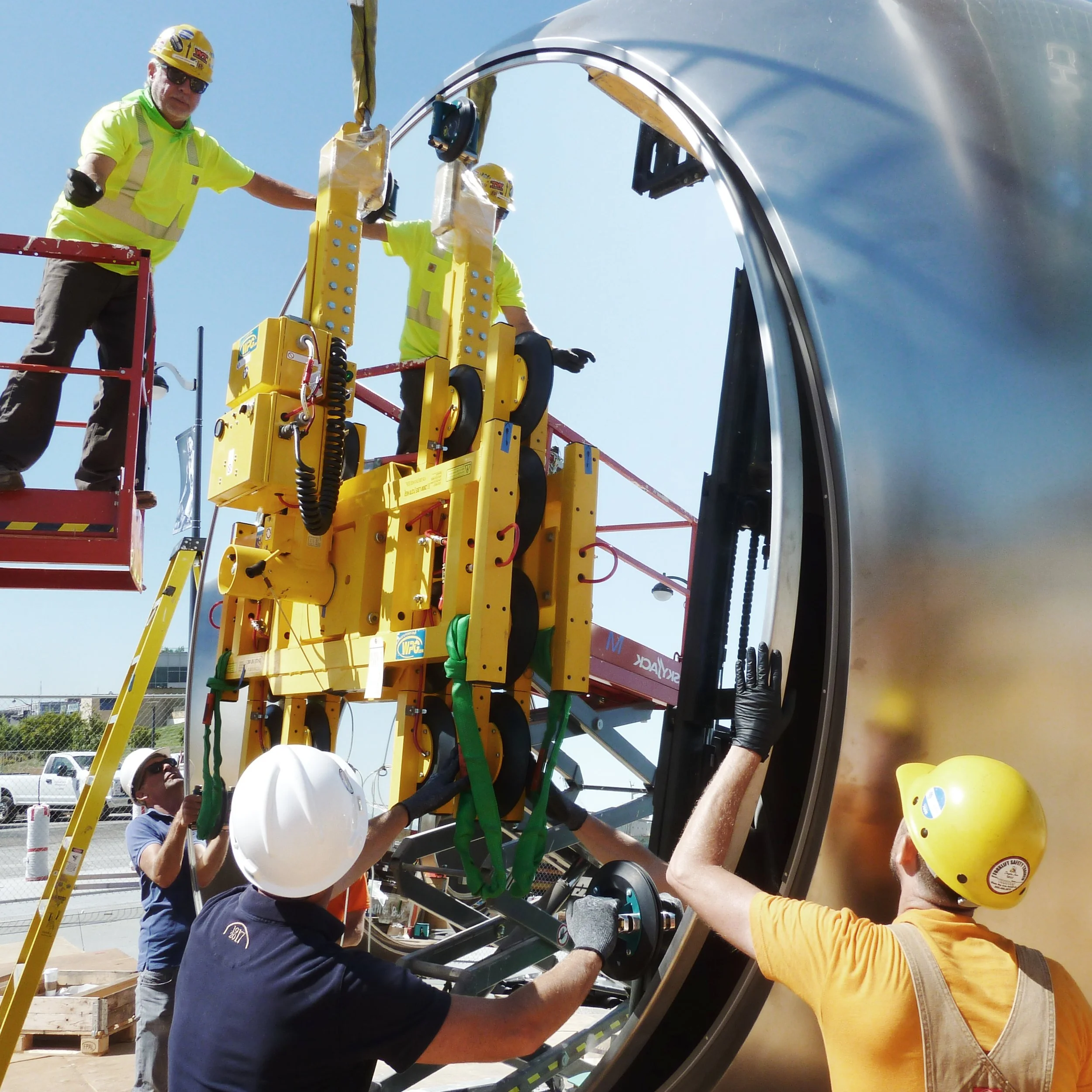 Atthowe staff installing a mirrored panel into one of Olafur Eliasson's "Seeing Spheres" at Chase Center, San Francisco, using a specialized transport tool.