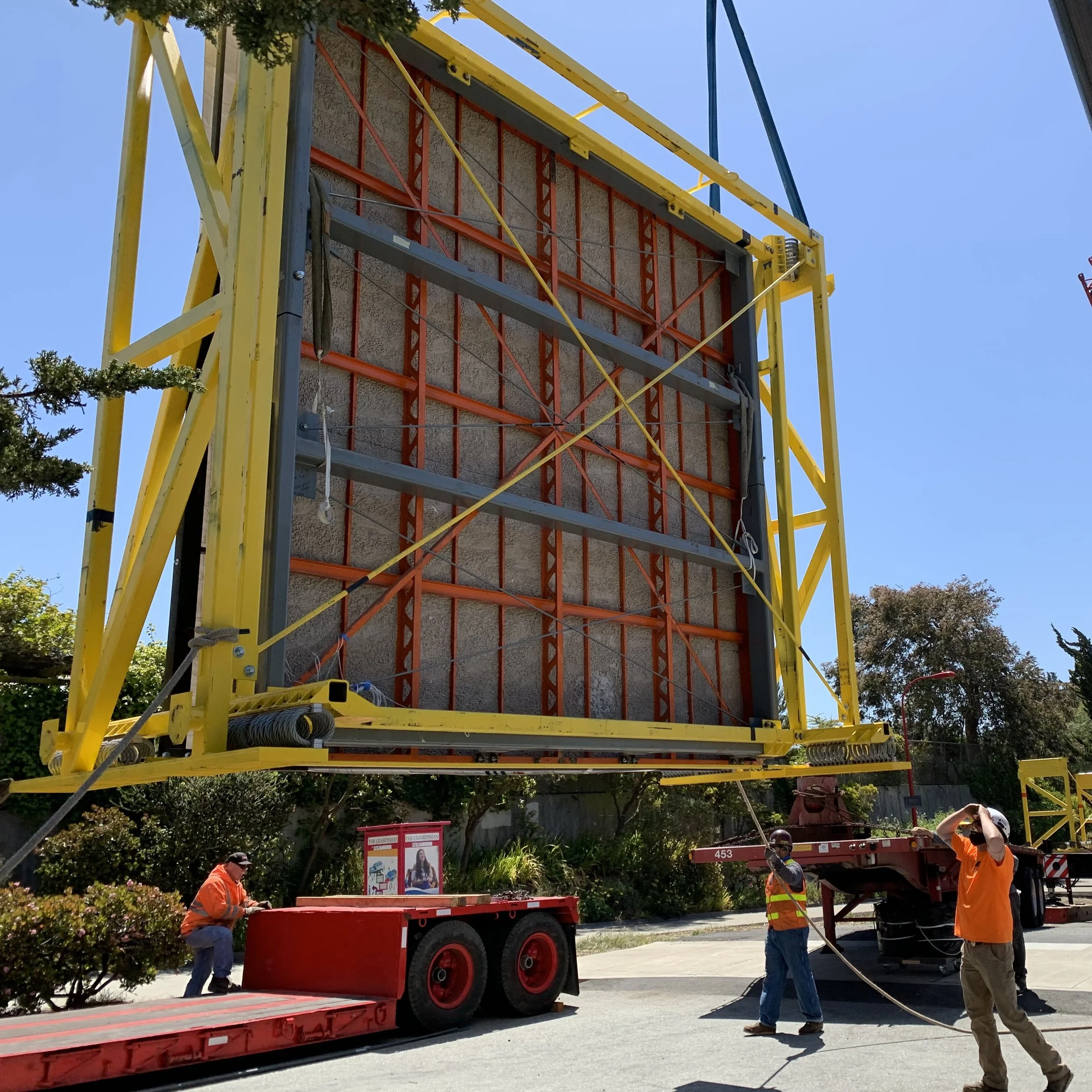 Atthowe staff moving a custom-fabricated frame built for transporting a panel of Diego Rivera's "Pan American Unity" mural, with the truck staged to receive it.
