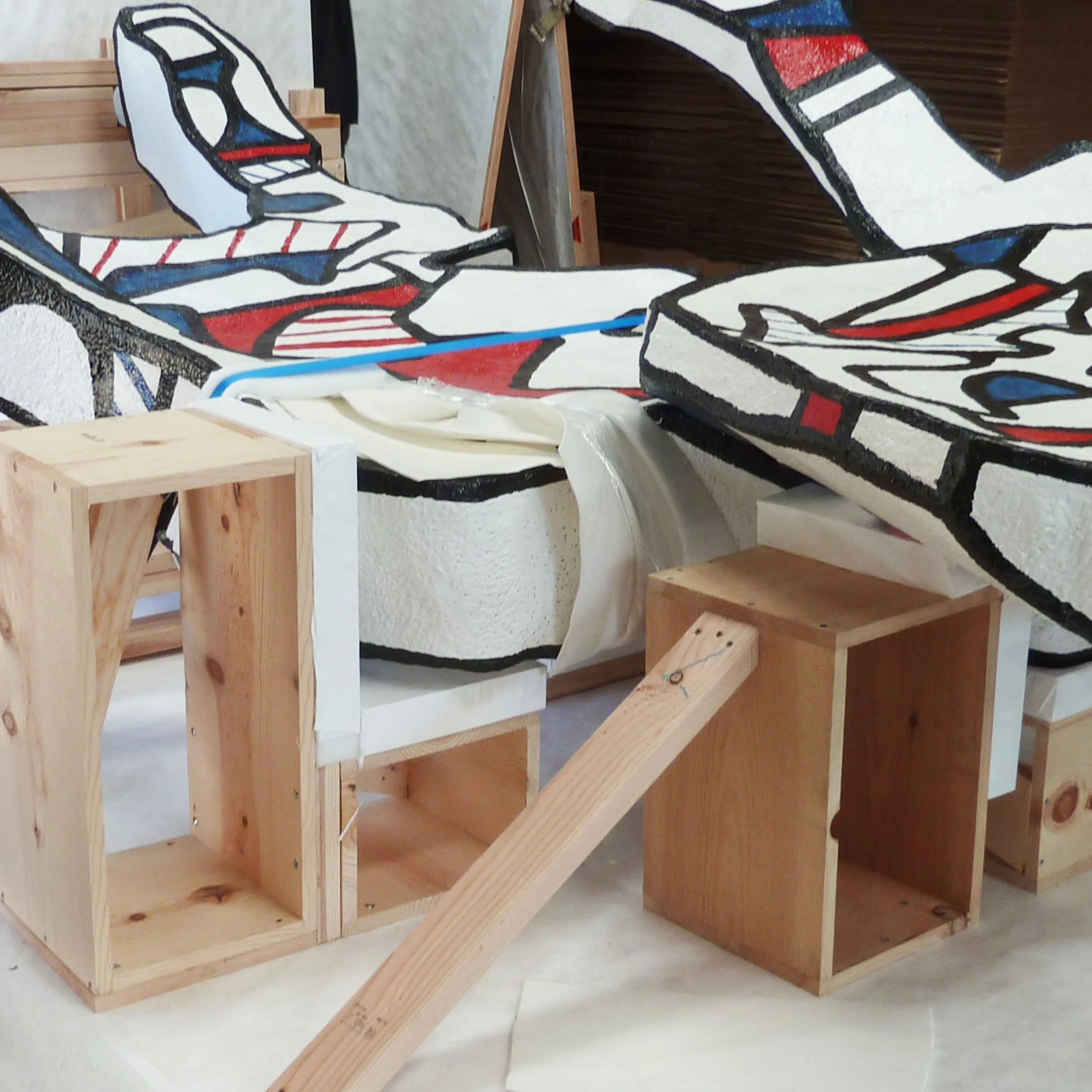 A colorful sculpture braced with custom wood and foam supports prepared for the inside of an Atthowe crate for safe transit.