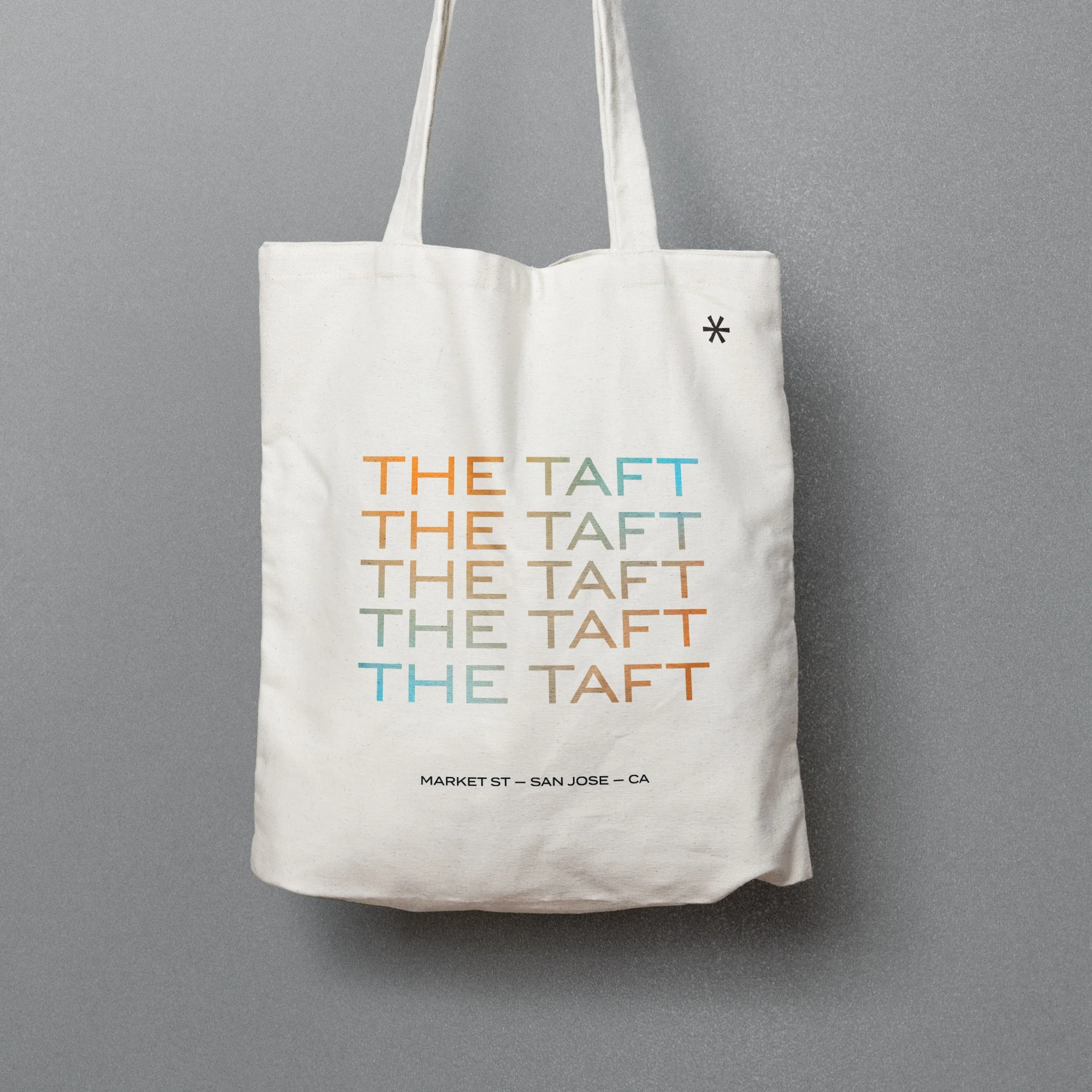 Tote bag featuring a repeated logo for The Taft.