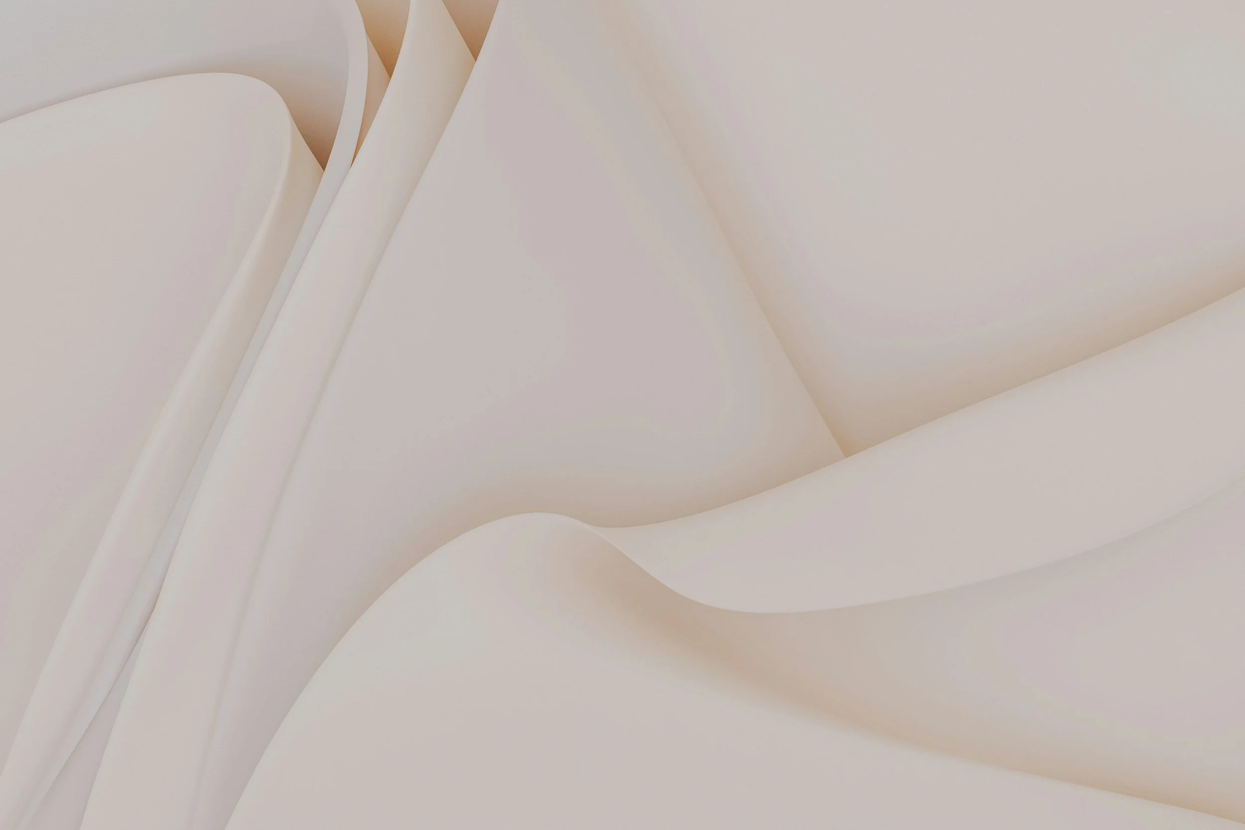 Close-up of smooth, cream-colored paper with curved edges and folds.