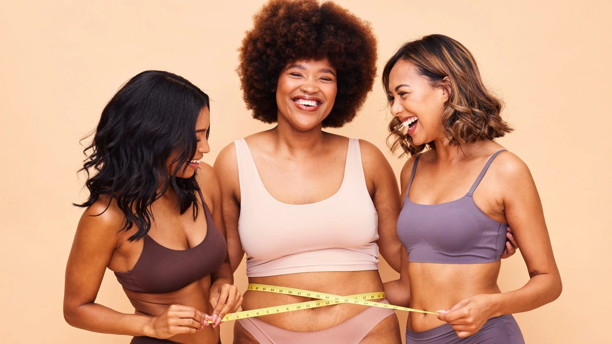 Person holding a smartphone on a video call with a female doctor wearing scrubs and a stethoscope.