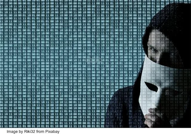 Image of man behind the mask with rows and rows of number in the backgroujnd