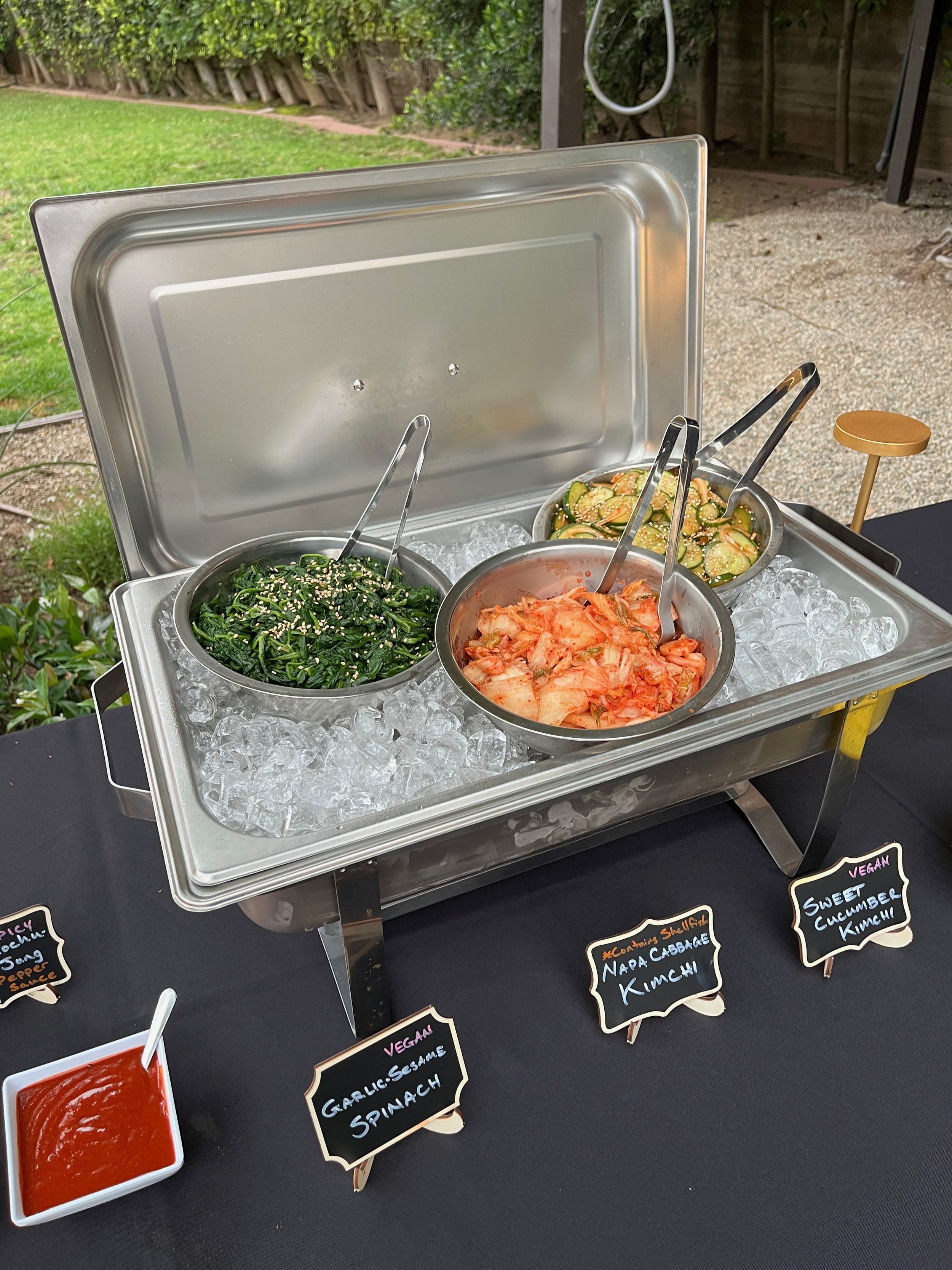 Traditional Korean BBQ buffet setup with grilled meats and banchan at a catered event in Southern California