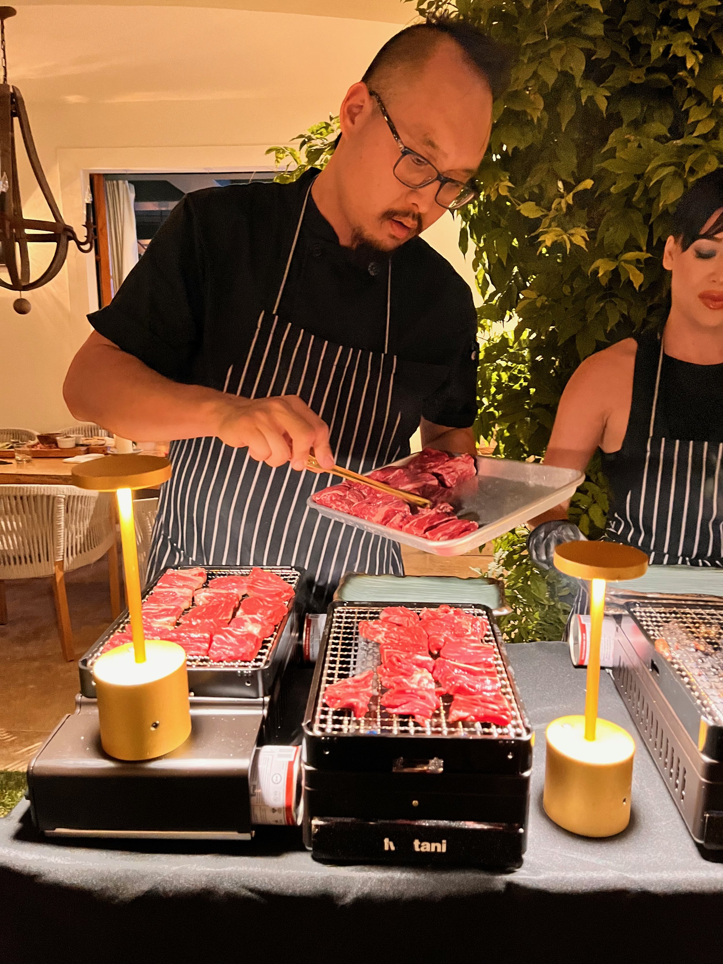 Omakase service by Chef John Bach, preparing premium Korean BBQ cuts tableside at a private event in Los Angeles