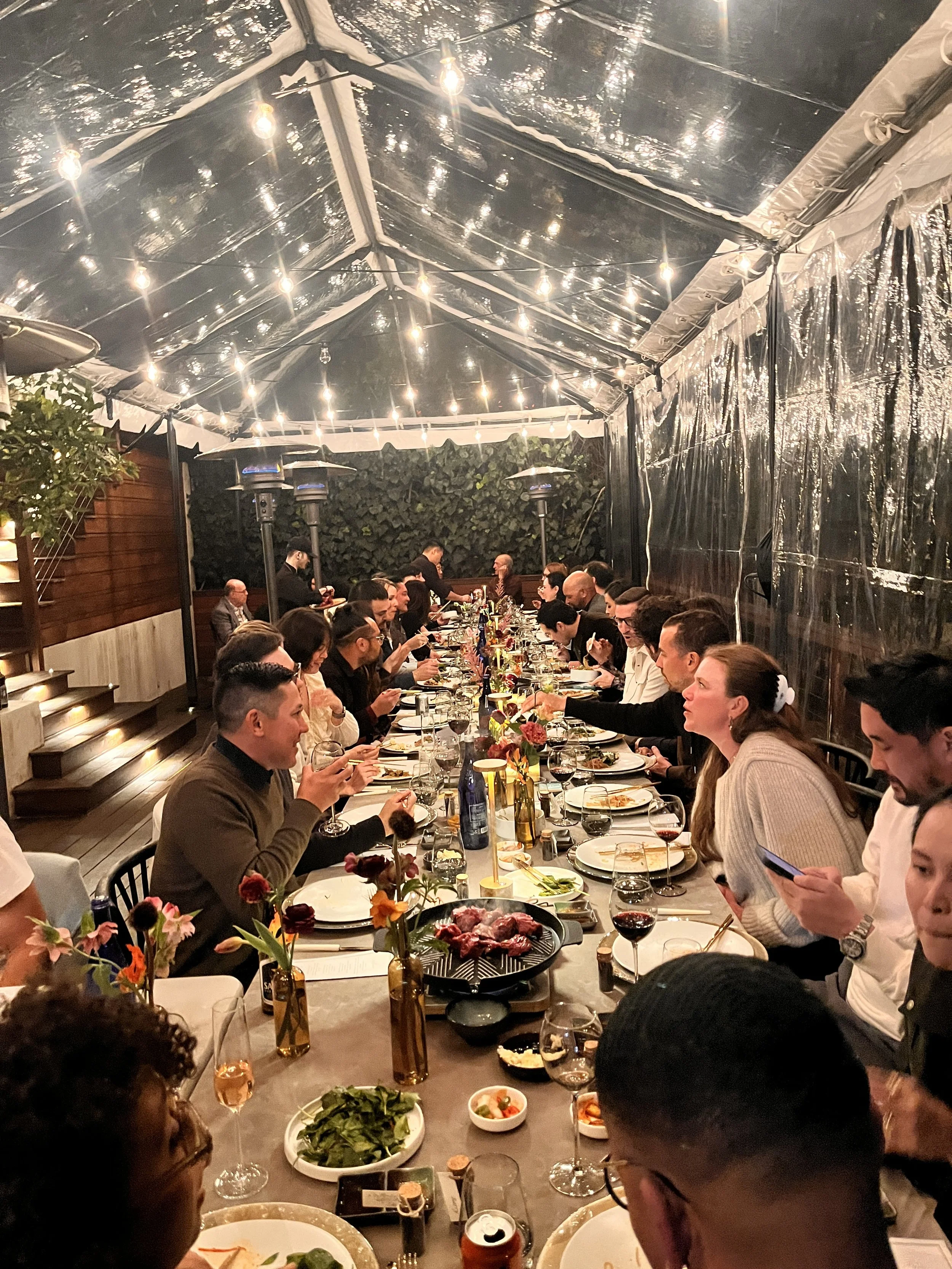 Guests enjoying interactive Korean barbecue catering at a backyard private party in Los Angeles, CA
