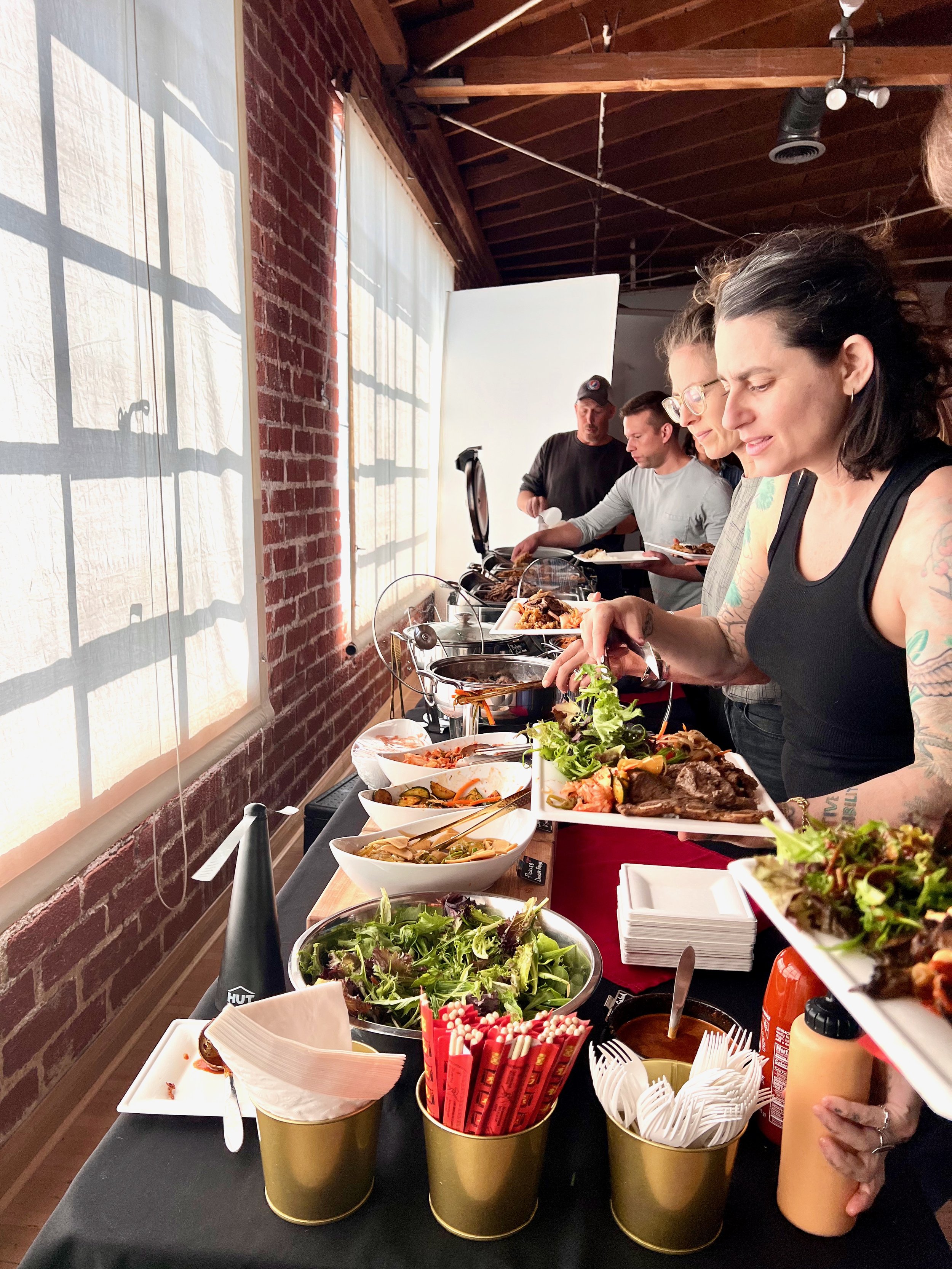 KBBQ buffet catering for a corporate lunch at a Hollywood production company, featuring Korean BBQ dishes and professional setup