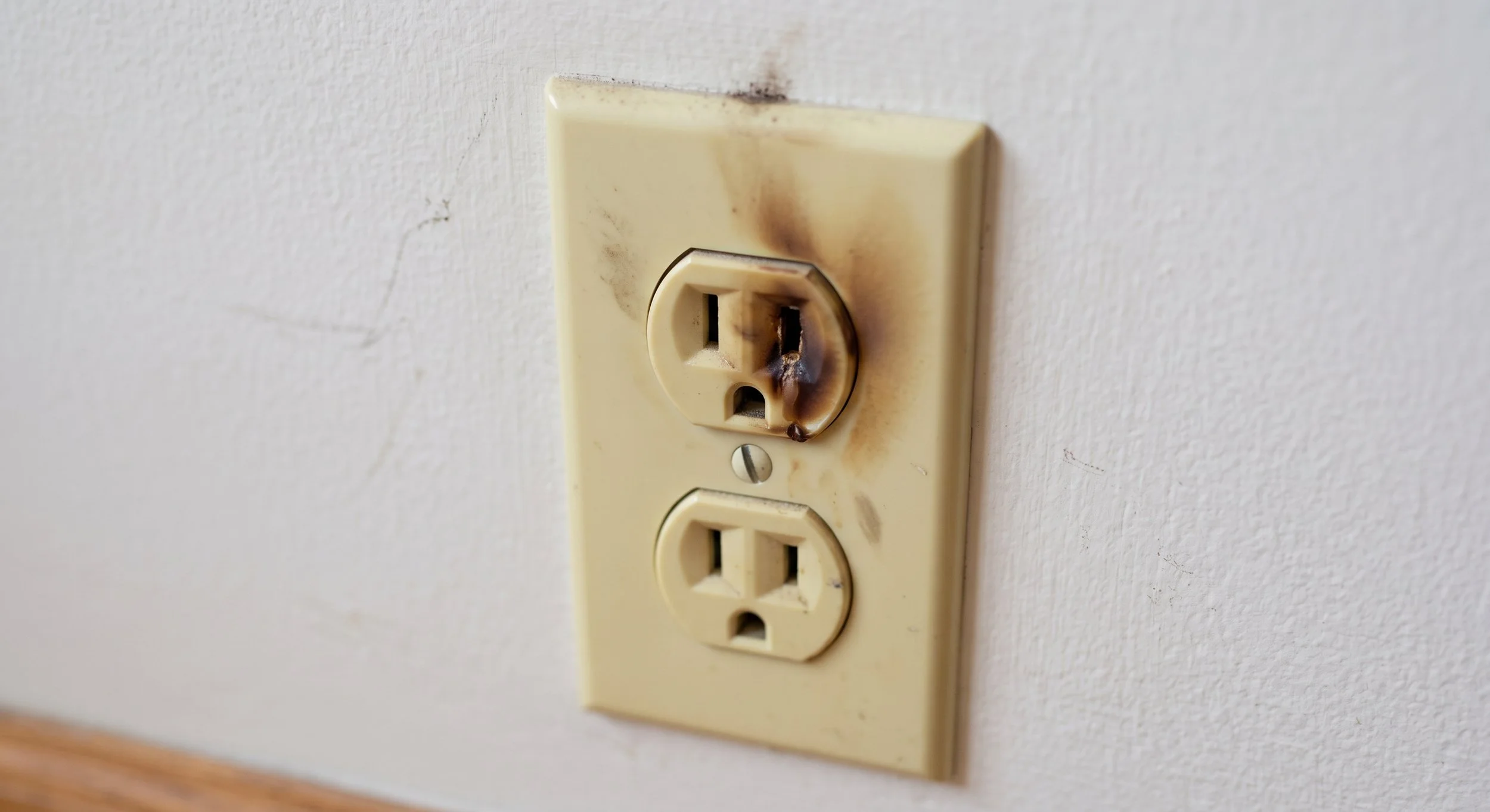 Outlet damaged from heat, blackening