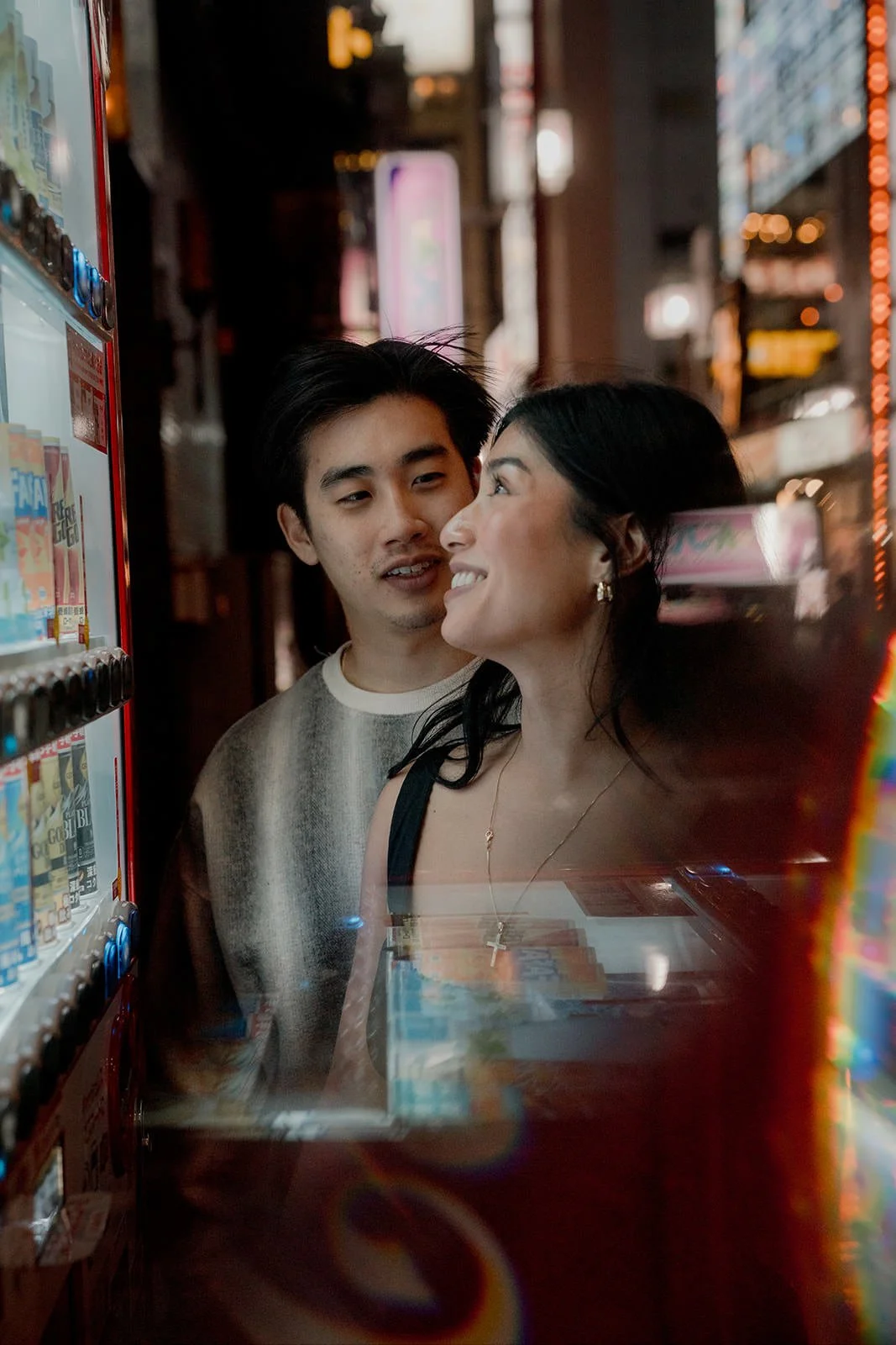 Couples photoshoot on rainy Shinjuku streets at night, Tokyo, spring evening