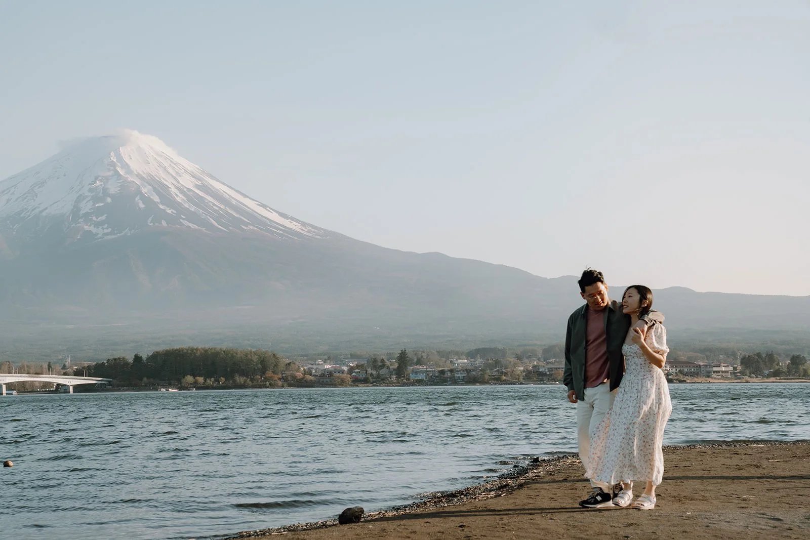 Proposal photoshoot at Lake Kawaguchiko at sunset with cherry blossoms and Mt. Fuji