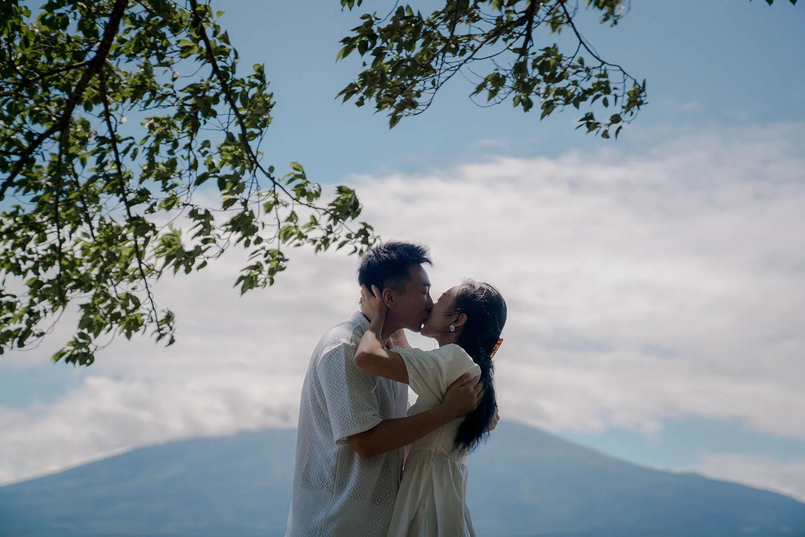 Couple embracing after the proposal Kogamasao Memorial Park Mt Fuji