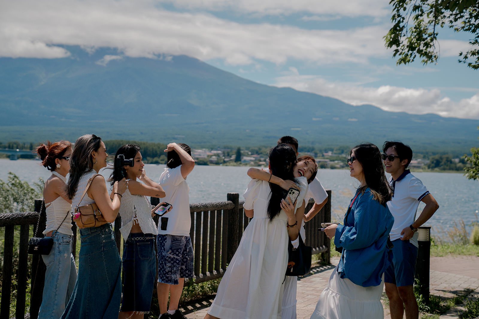 Group celebration after surprise proposal reveal at Kawaguchiko