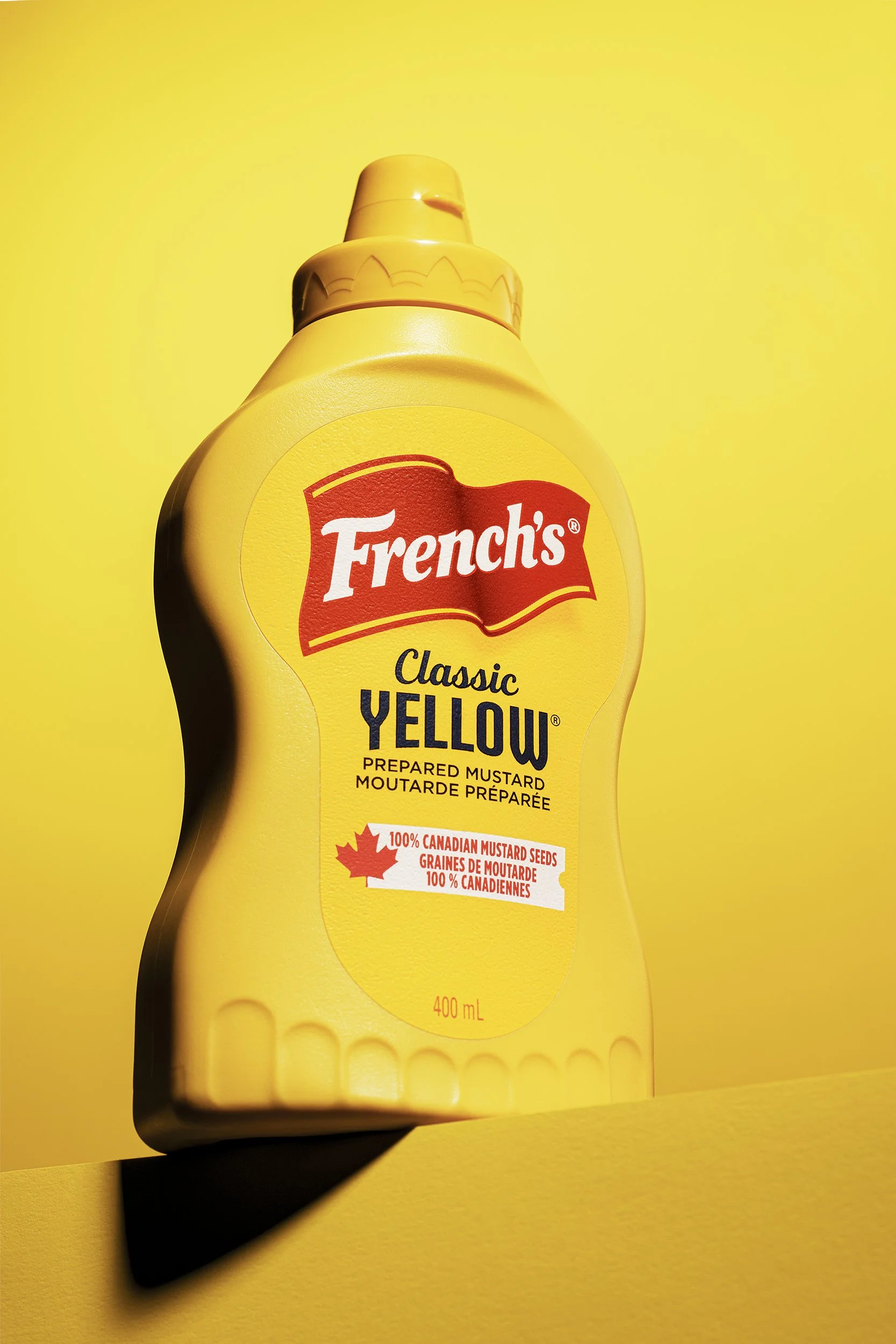 Frenchs Classic Yellow Mustard bottle photographed with full tonal match on yellow