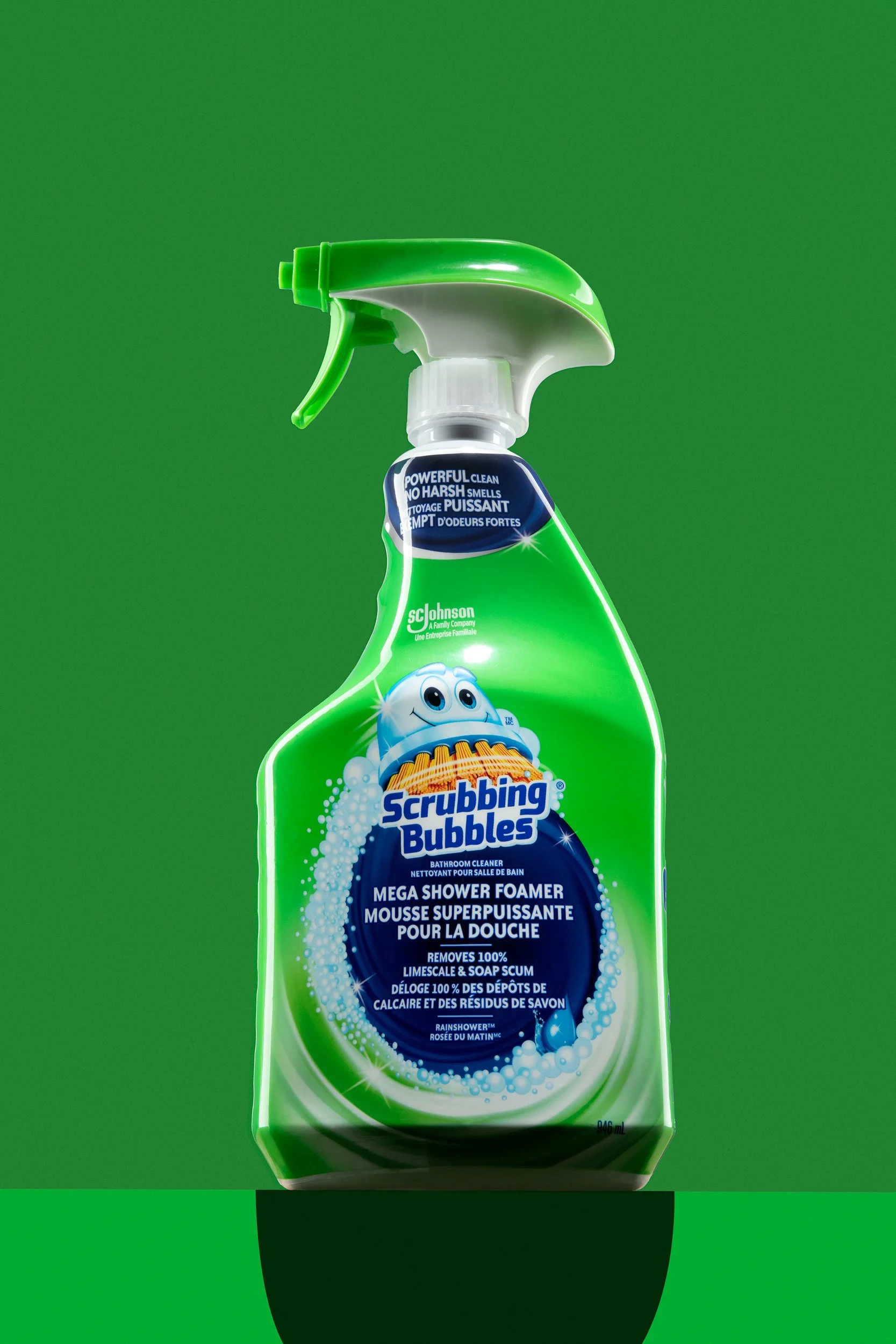 Green spray bottle of Scrubbing Bubbles Mega Shower Foamer on a clean green surface