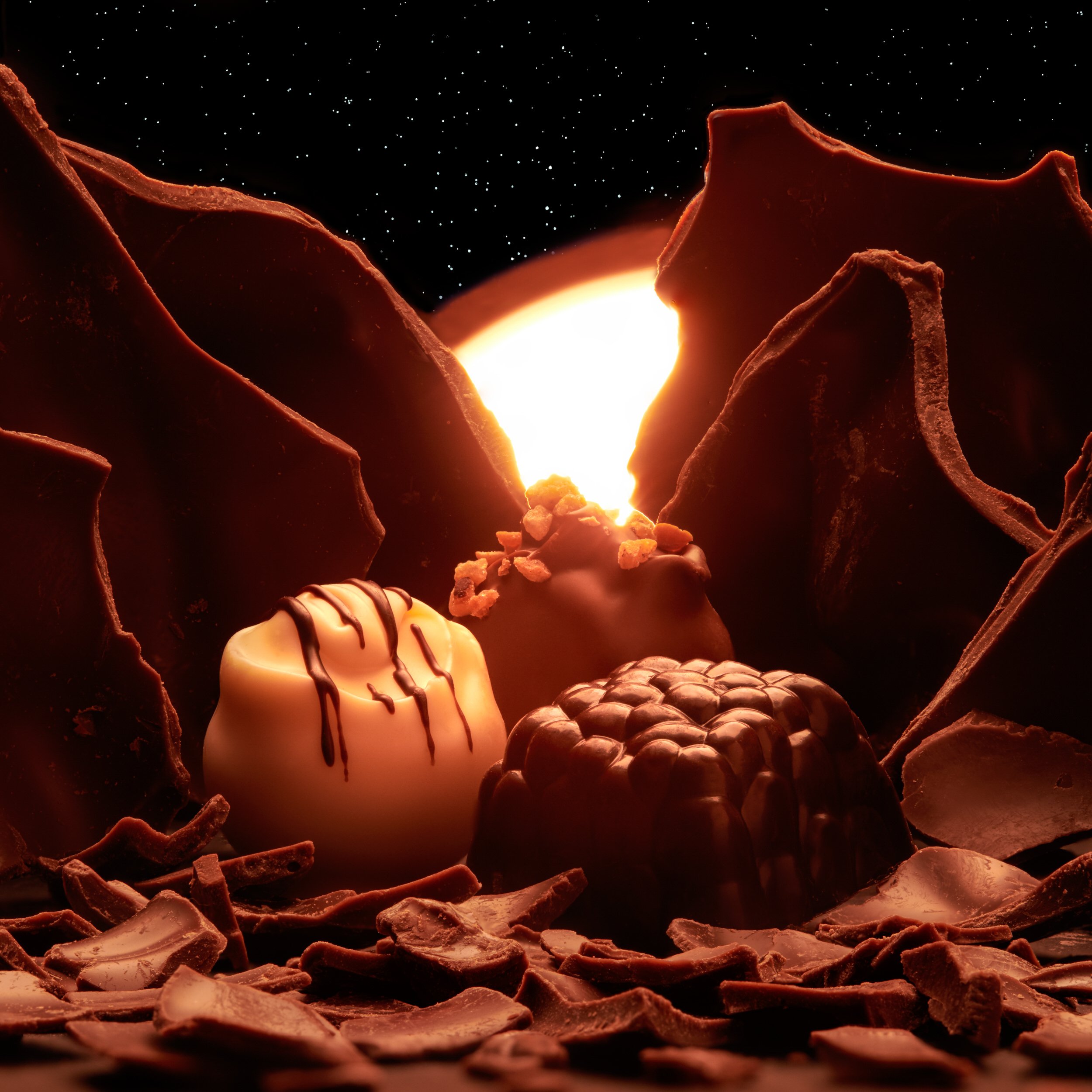 Chocolate truffles with cracked chocolate on glowing orange background