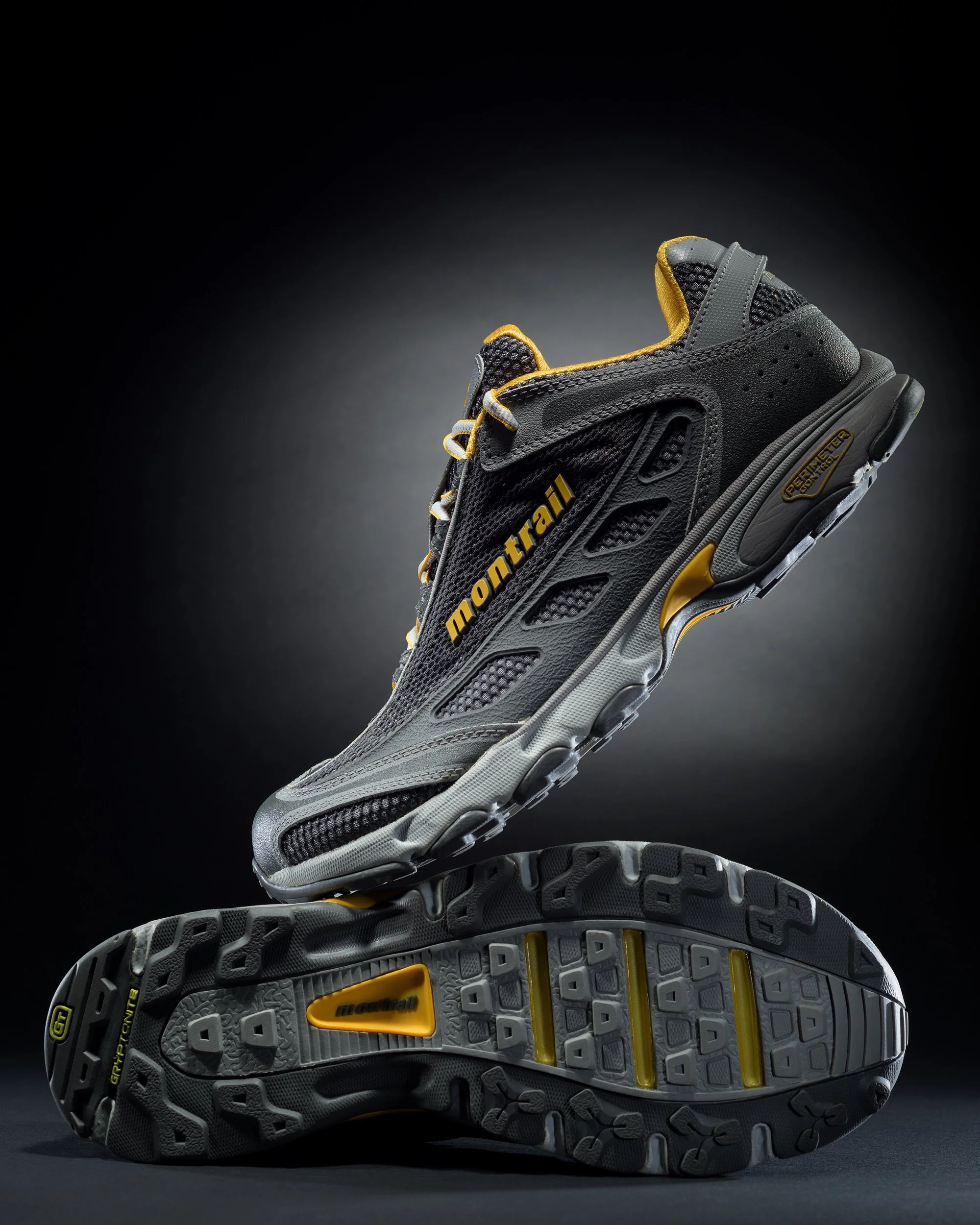 Pair of Montrail trail running shoes in midair showing tread and side detail