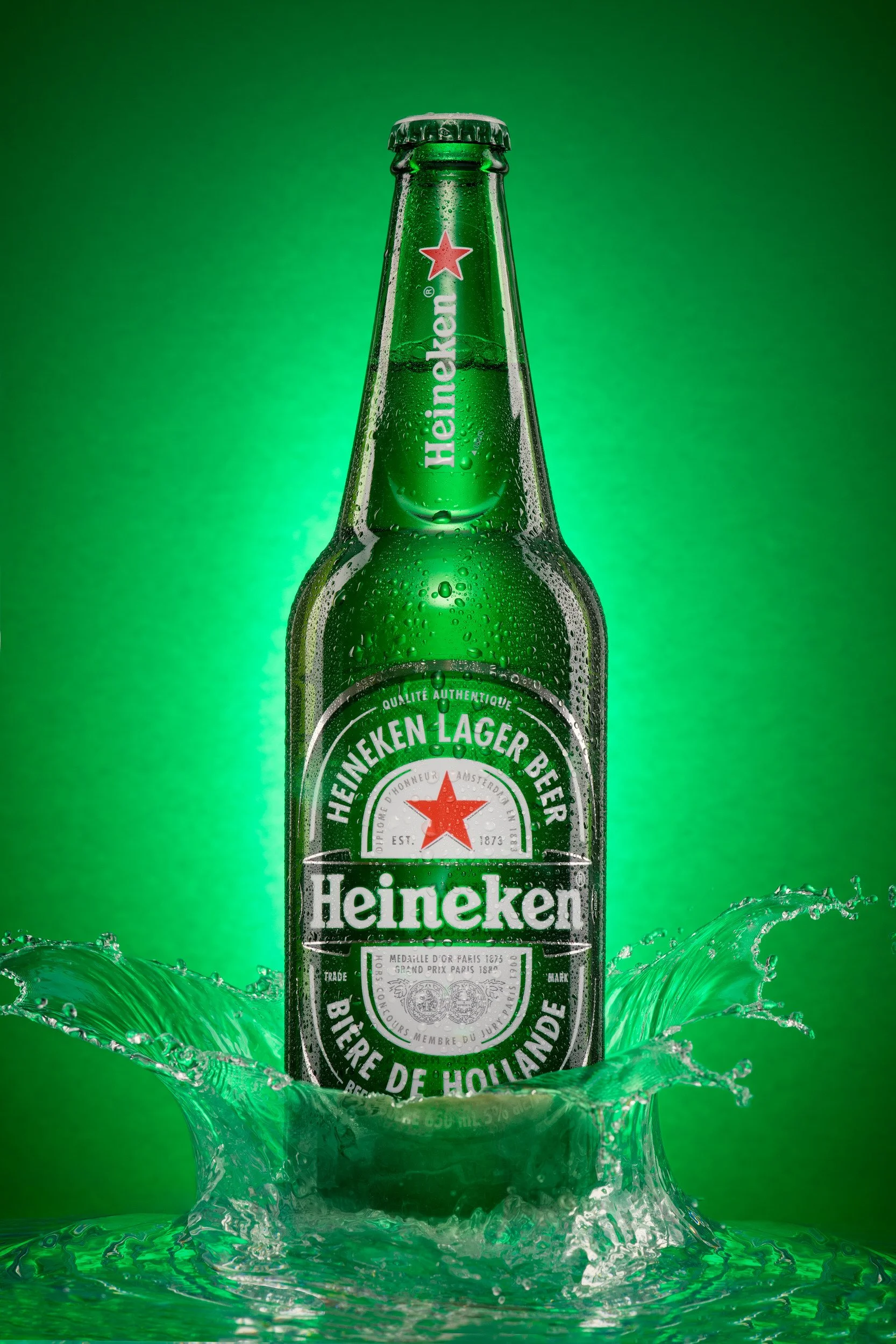 Heineken lager beer bottle with splash effect and condensation
