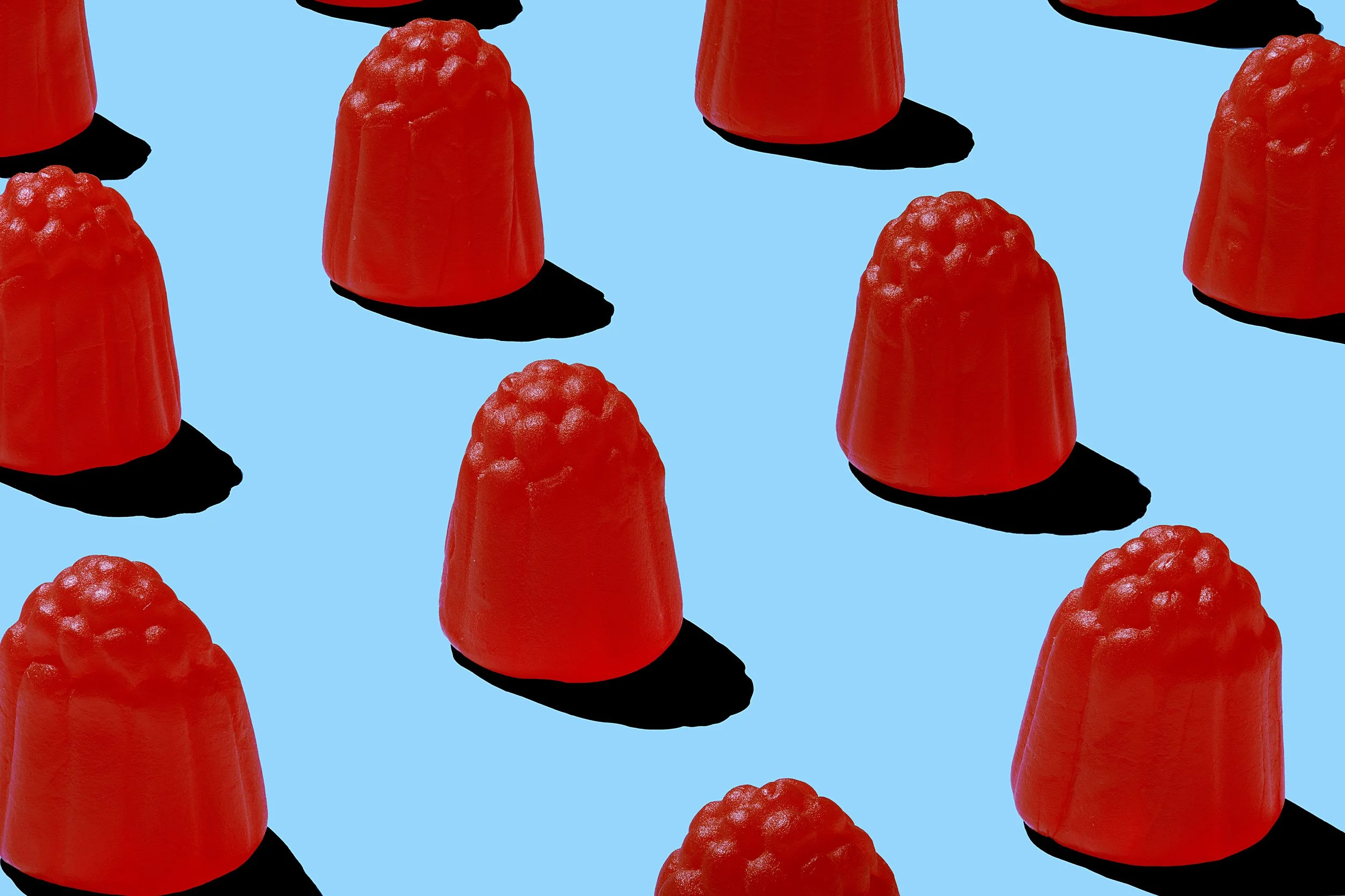 Mondoux red raspberry candy pattern on blue surface, food photographer Montreal 