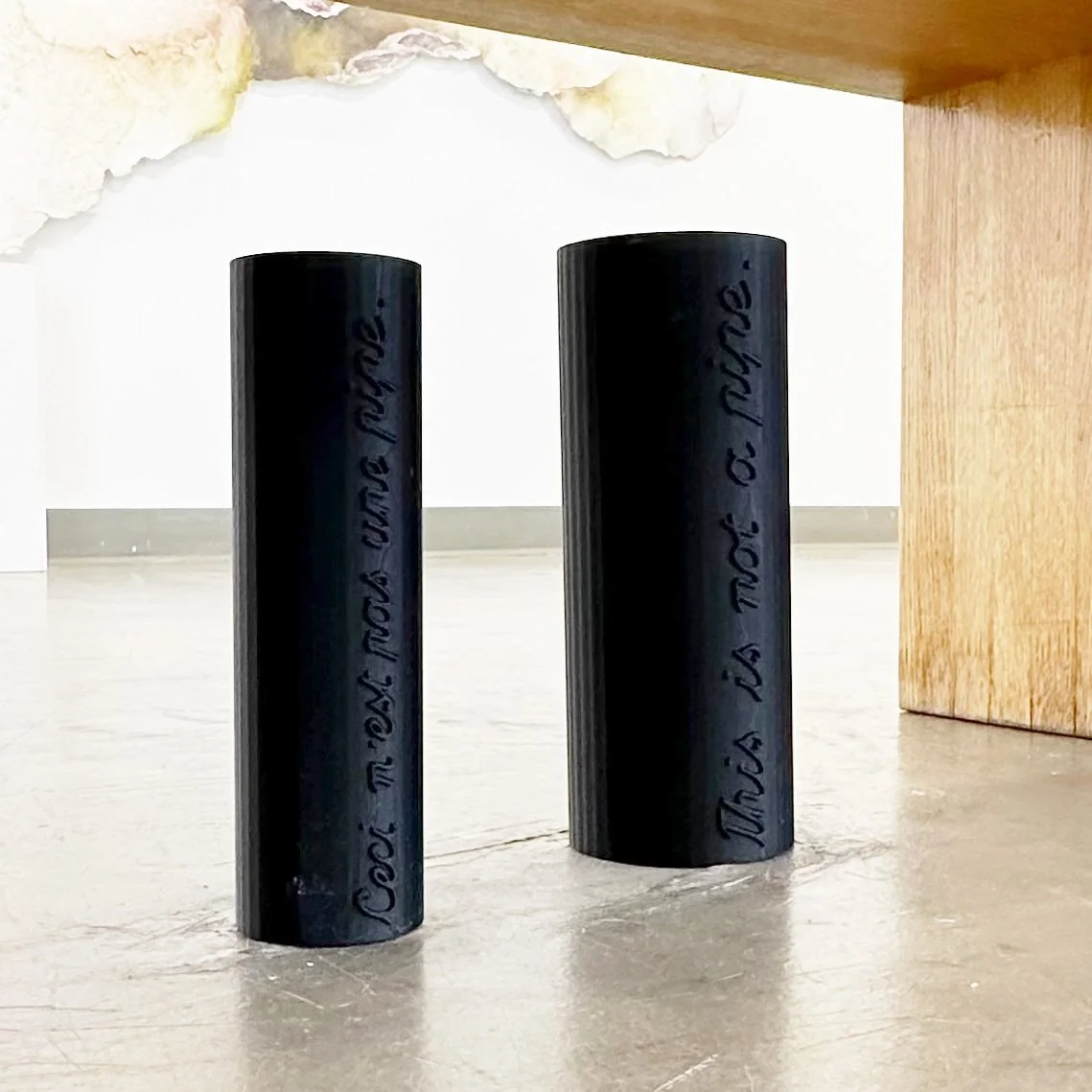 two black cylinders with text on them
