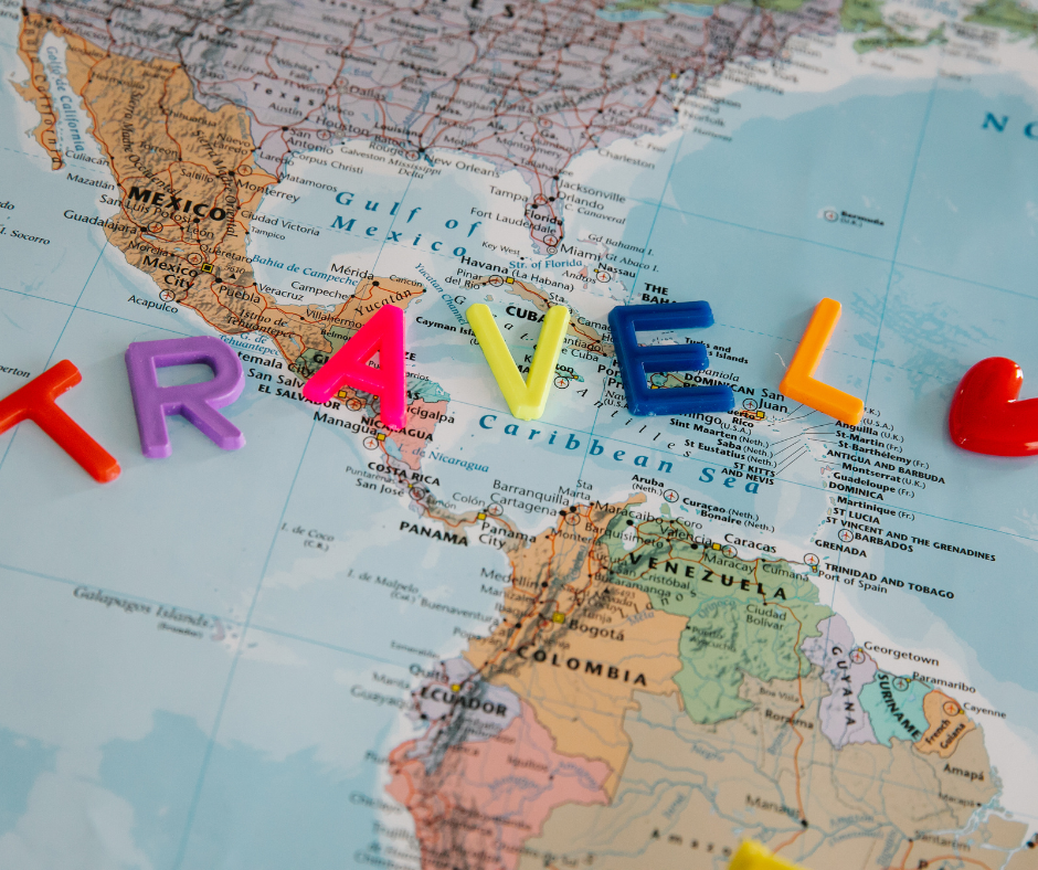 A map with letters spelling travel placed over it.