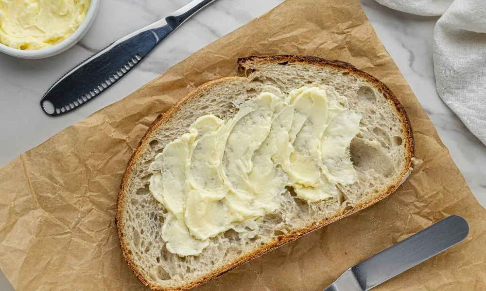 a-piece-of-bread-with-butter-on-top-of-it