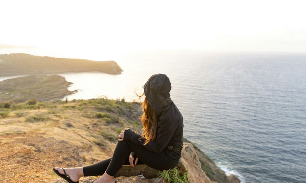 woman-sits-and-watches-the-sea-view