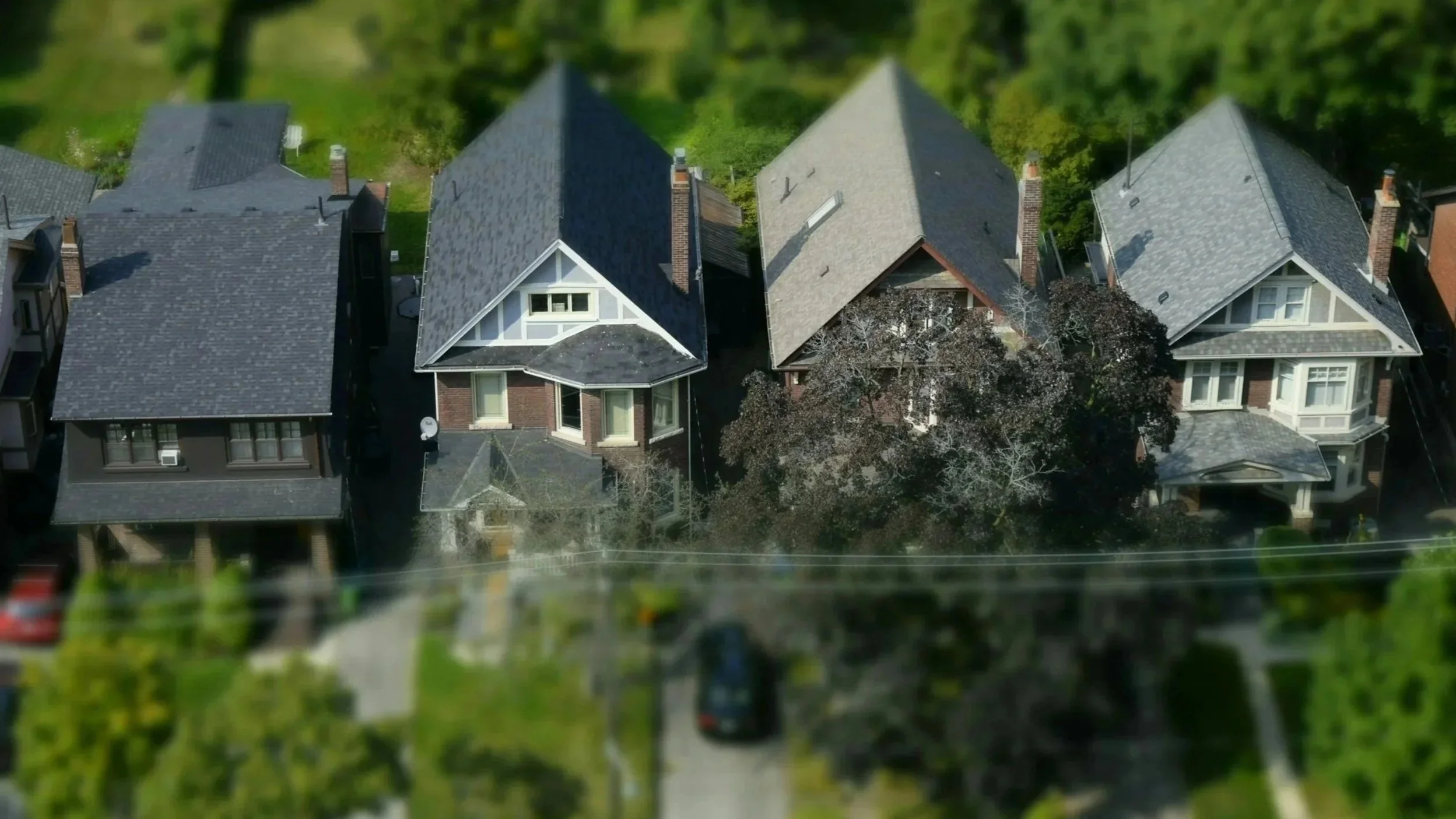 Aerial view of four neighborhood homes.