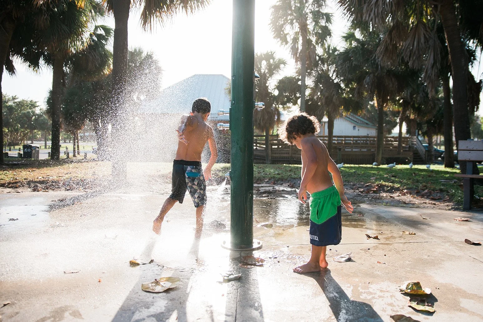 Boys playing in beach shower in Singer Island FL