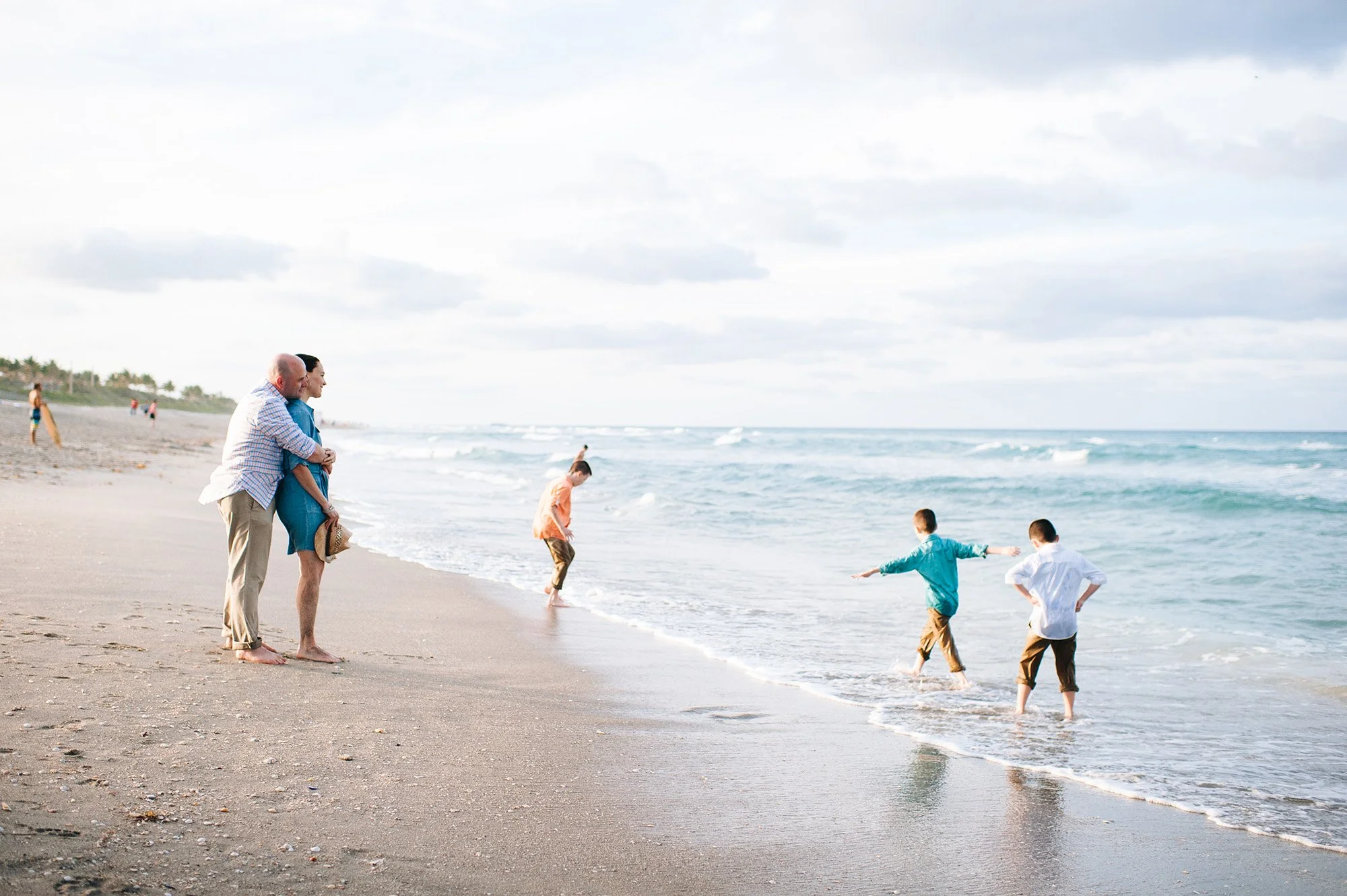 Family playing at edge of water Lake Worth FL