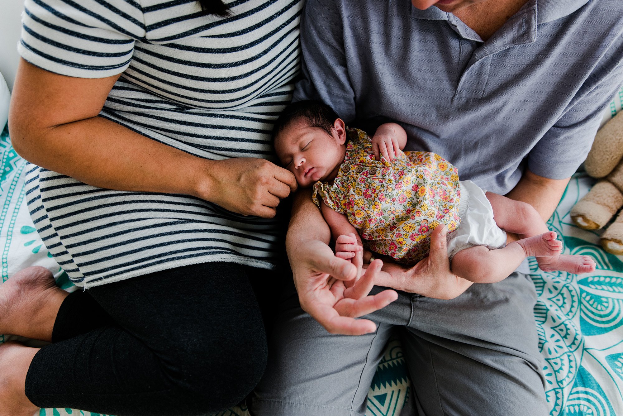 Father and Mother holding newborn baby girl