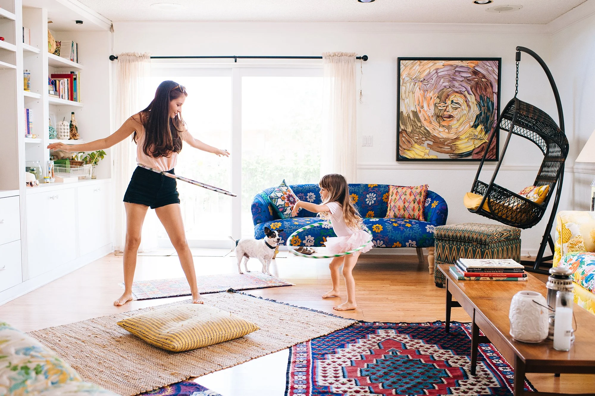 Mother and daughter hula hoop in living room during Palm Beach indoor family photography session