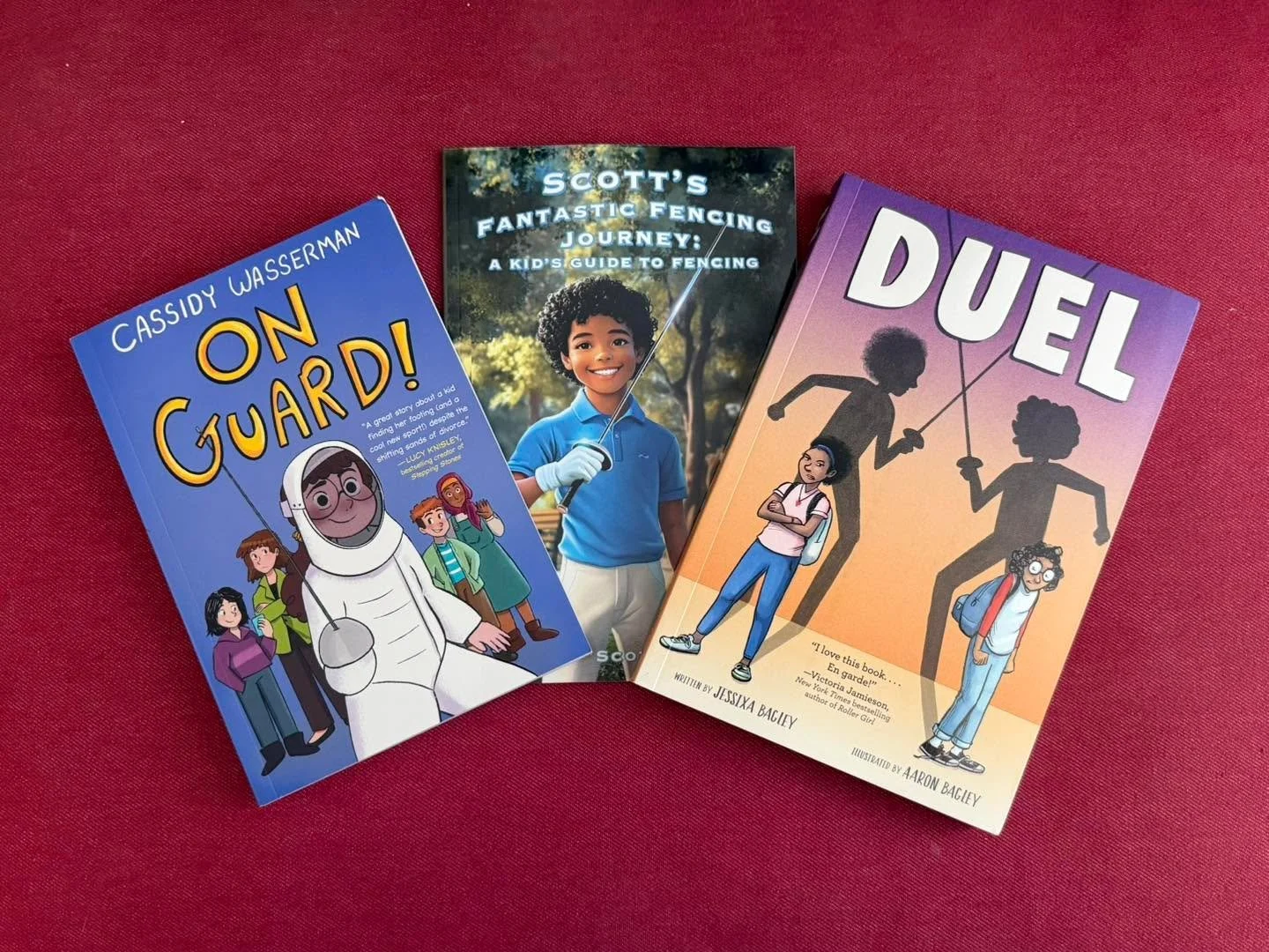 These fencing books will be added to the fencing club library soon! The only reason they haven’t been yet is because I (Coach Annamaria) want a chance to read them.
On Guard! (by @caswasshere) and Duel (@jessixabagley) are both graphic novels.