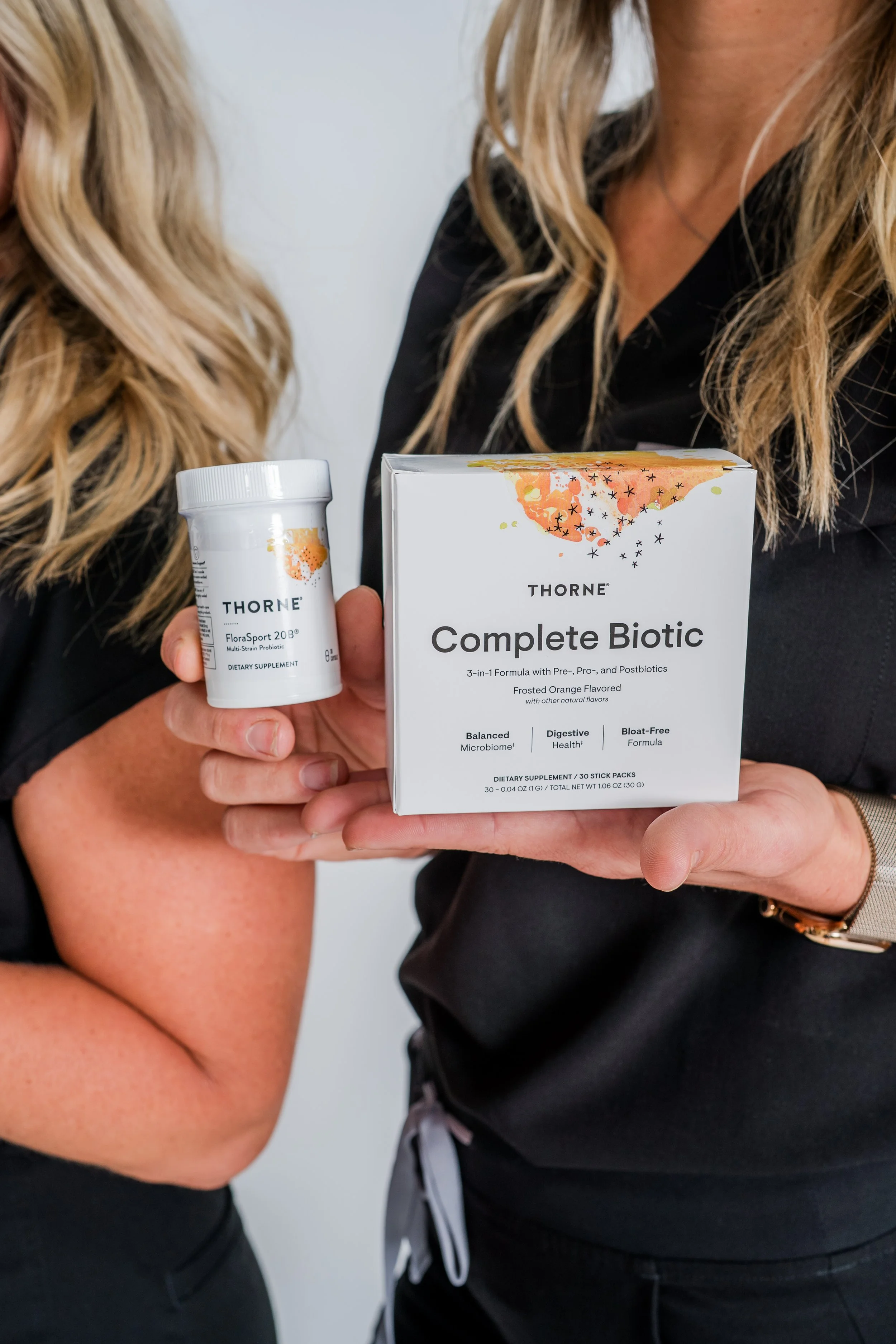RN holding Thorne supplements