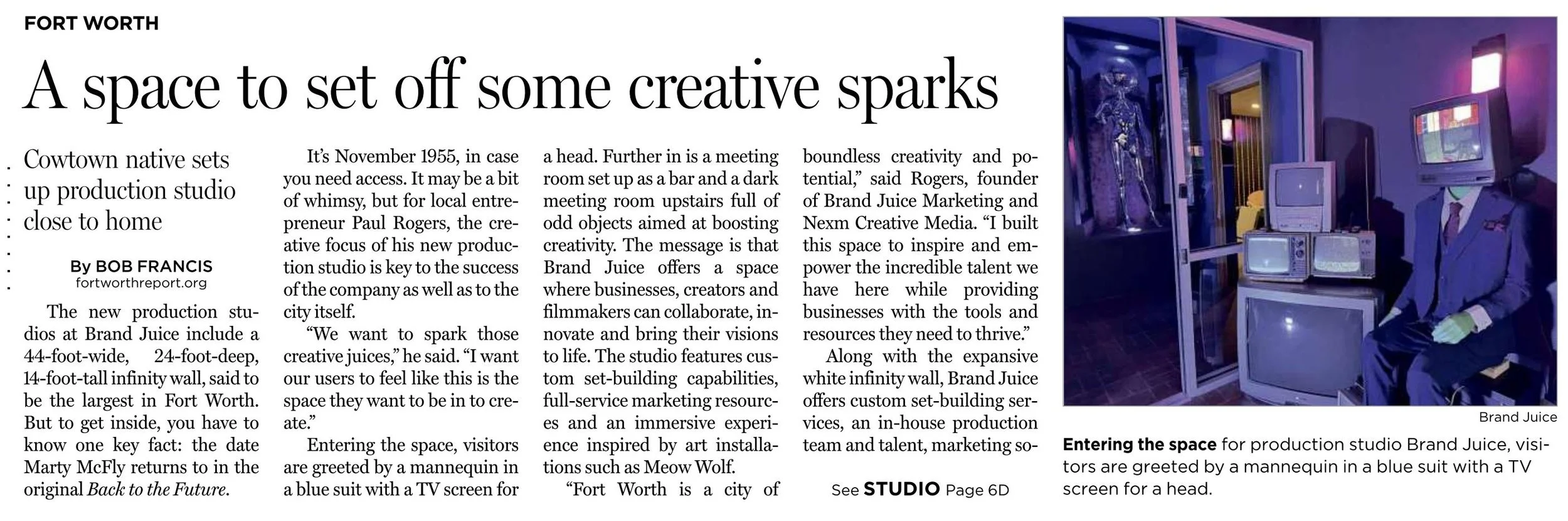 Photo of a person in a blue suit with a TV screen for a head, sitting in a room with vintage TV monitors and a skeleton display case, inside a production studio at Brand Juice.