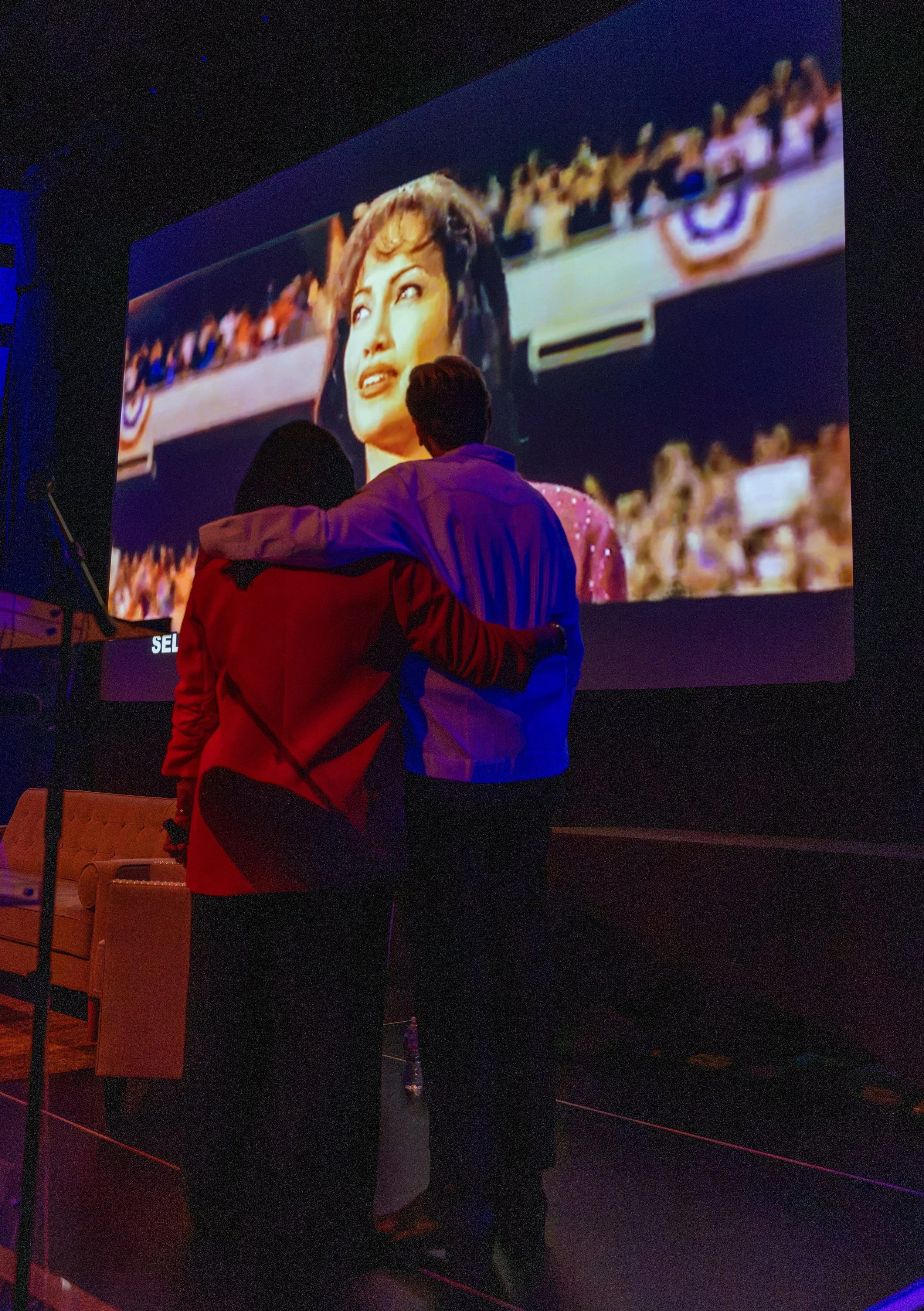 SUZETTE AND GREG WATCHING TRUBUTE.jpg