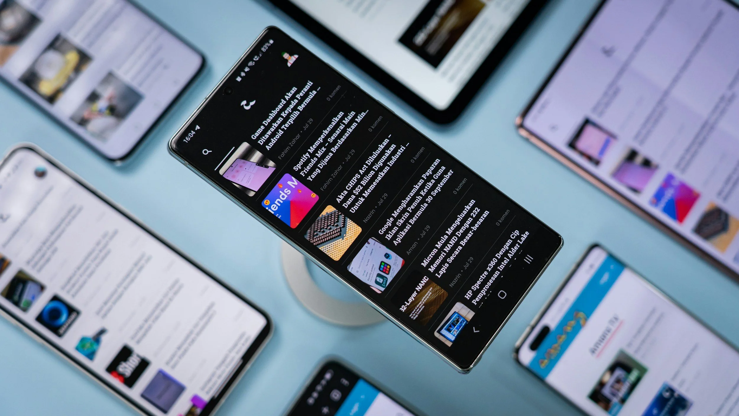 Multiple smartphones displaying social media and news feeds, representing digital media consumption and entertainment news online.