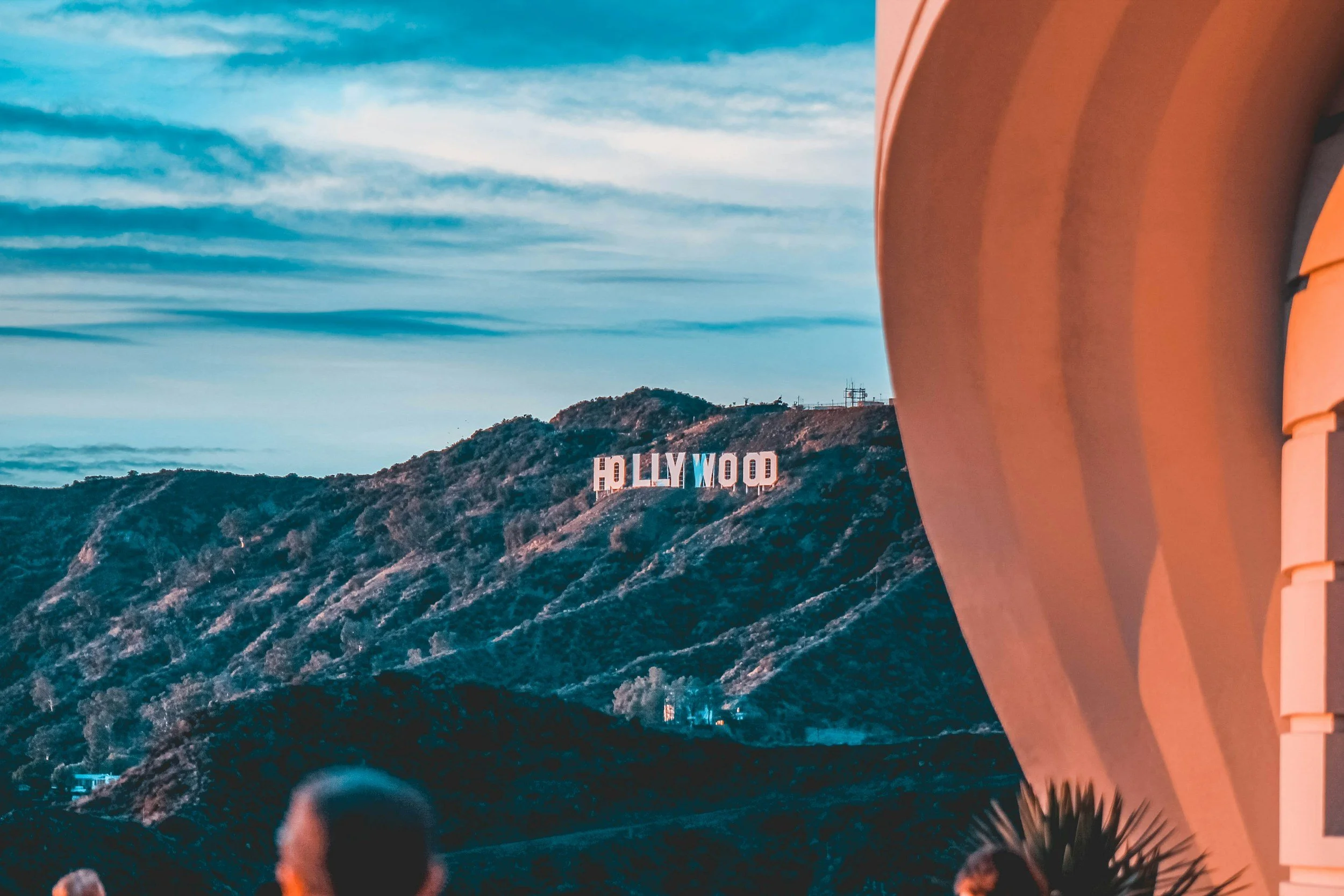 View of the Hollywood sign on a hillside in Los Angeles, California under clear sky