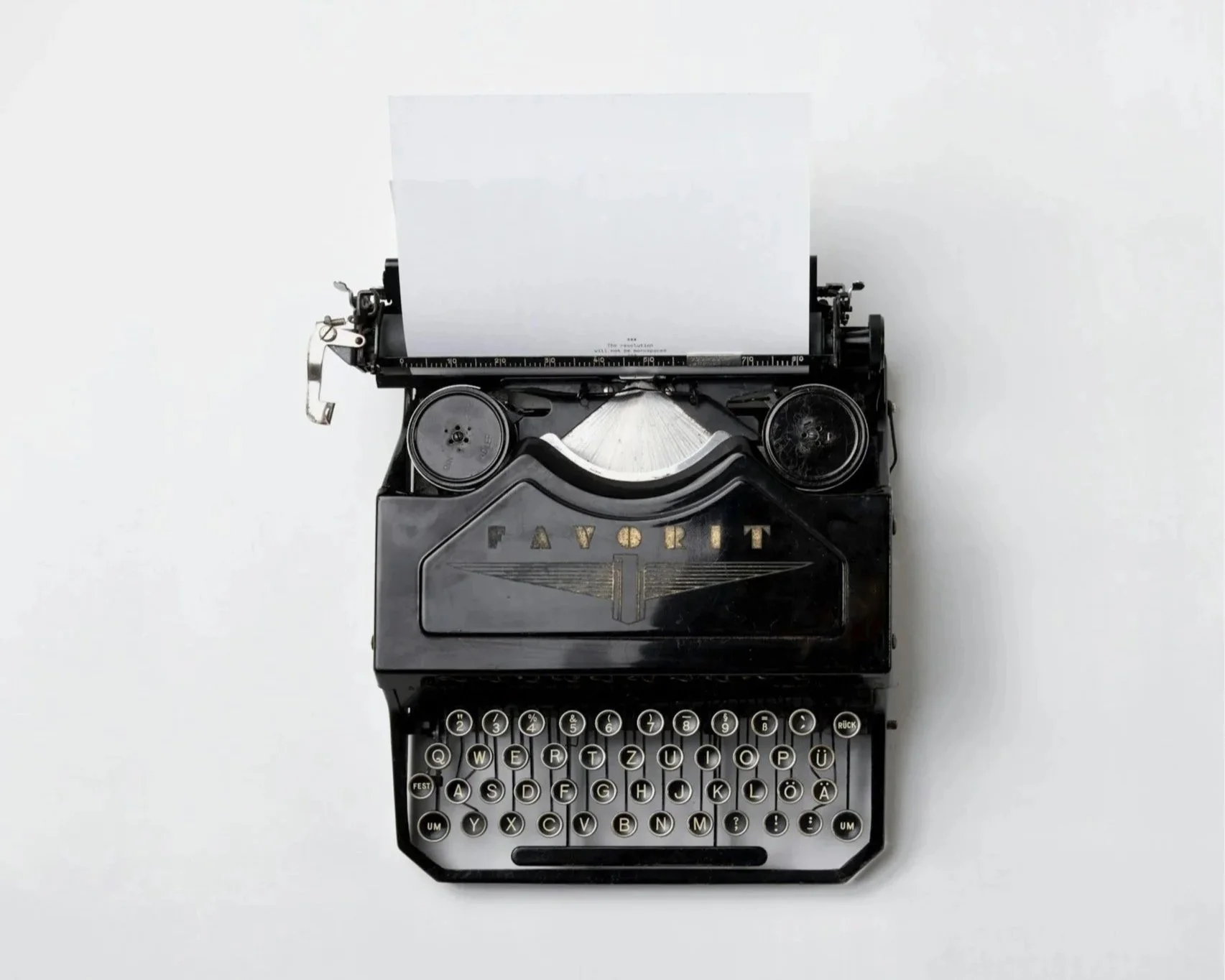 Overhead view of a vintage typewriter on a desk, representing film journalism, awards season commentary, screenwriting, and cinematic storytelling analysis.