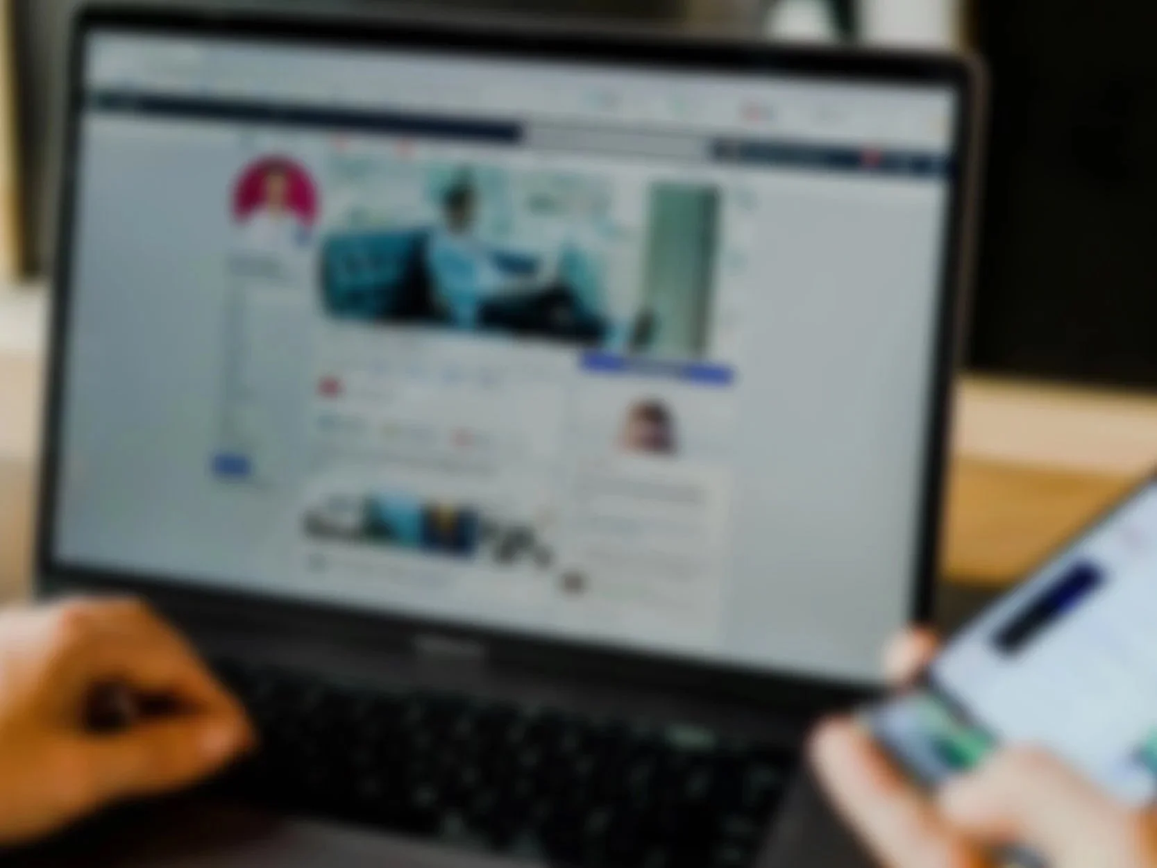 Person multitasking with a laptop and smartphone, representing modern work, digital connectivity, and the intersection of technology and productivity.