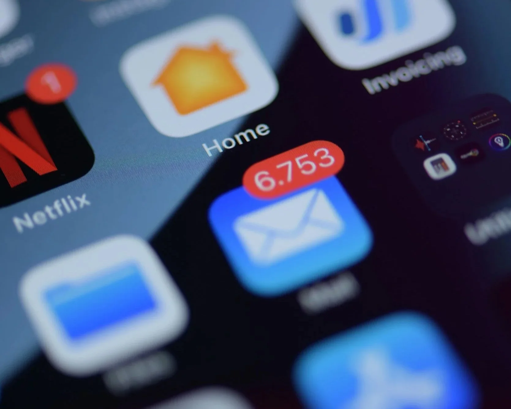 A close-up of a smartphone screen displaying an email notification, representing constant digital interruption and fragmented attention in modern media consumption.